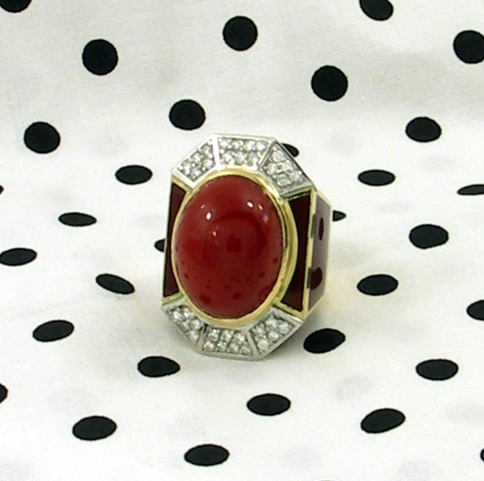 An 18K yellow gold, geometric design ring, set with 34 round brilliant cut diamonds, weighing 1ct total approximate weight, of overall G color and VS1 clarity. At the center of the ring is an oval cabochon cut ox blood coral, measuring 24mm X 18mm,