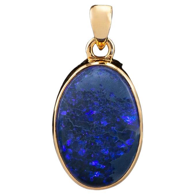 An unisex 18K yellow gold pendant with natural Black Opal 
opal origin - Australia 
opal measurements - 0.2 х 0.47 х 0.71 in / 5 х 12 х 18 mm
opal weight - 8.40 carats
pendant length - 1.02 in / 26 mm
pendant weight - 3.76 grams

Minimal