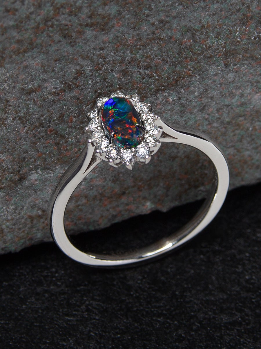 14K gold ring with Black opal and diamonds 
opal origin - Australia 
opal measurements - 0.079 х 0.16 х 0.28 in / 2 х 4 х 7 mm
opal weight - 0.71 carats
ring size - 7 US (this ring may be resized, please contact us for further information) 
ring