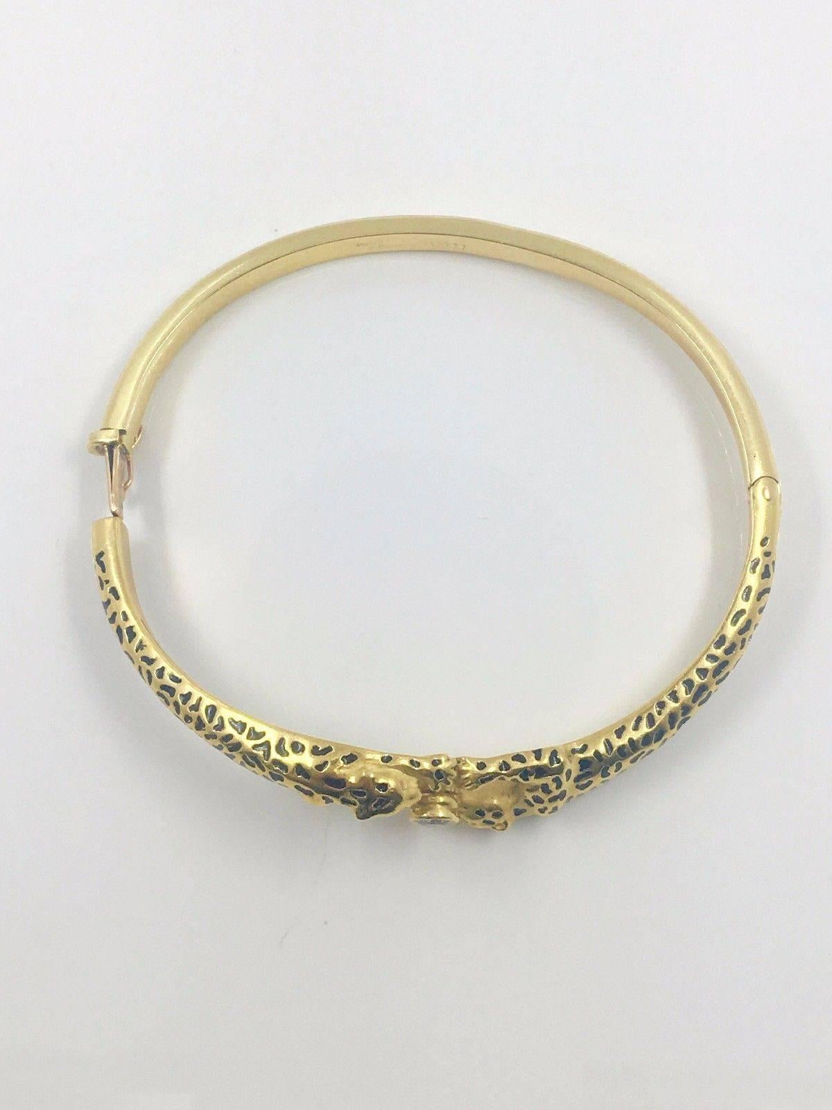 Perfect for everyday wear. Double Panthers holding each others grip with a 0.5 ct diamond at the center of their arms meetings. Beautiful and shiny yellow gold. Pairs well with other yellow gold and diamond bracelets, such as our Cartier LOVE