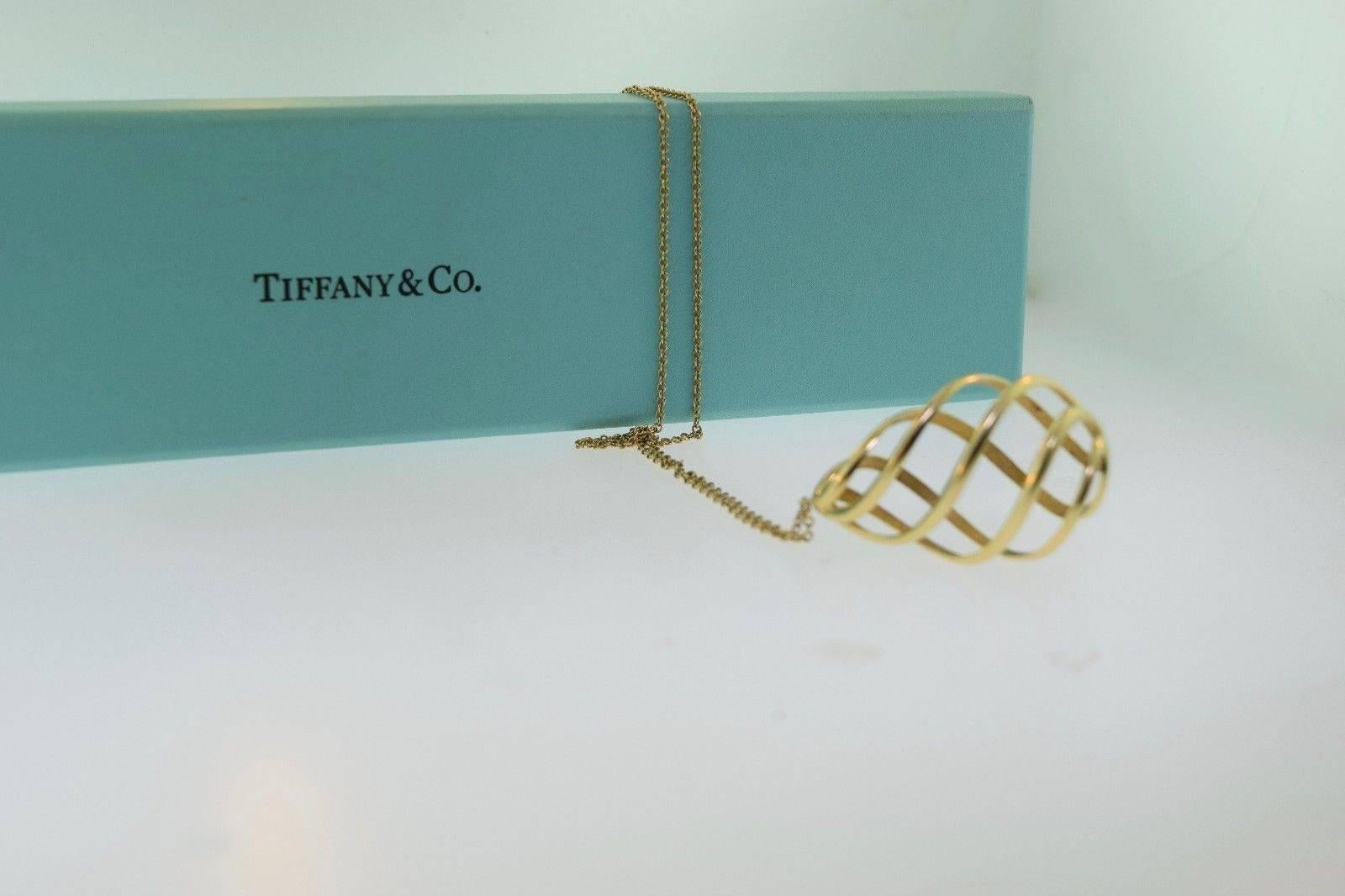 Description: 

18K yellow gold spiral necklace signed and designed by the famous Tiffany & Co. Uniquely crafted, and special in design, this piece can be worn as an everyday pendant to add that extra sparkle to your outfit. Contains TWO closing
