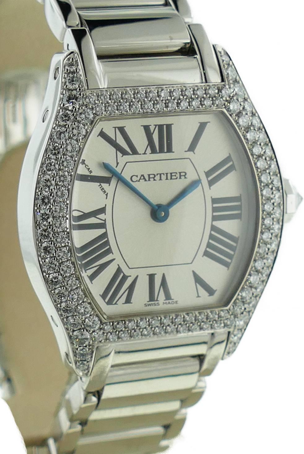  Ladies (28x35mm) Cartier Tortue 18k White Gold Factory Diamond Double Row Bezel Watch on a Bracelet. The Watch is in Good Condition & Keeping Great Time; Movement is Operated by Mechanical Hand Winding. Included with the Watch is a Cartier Box and