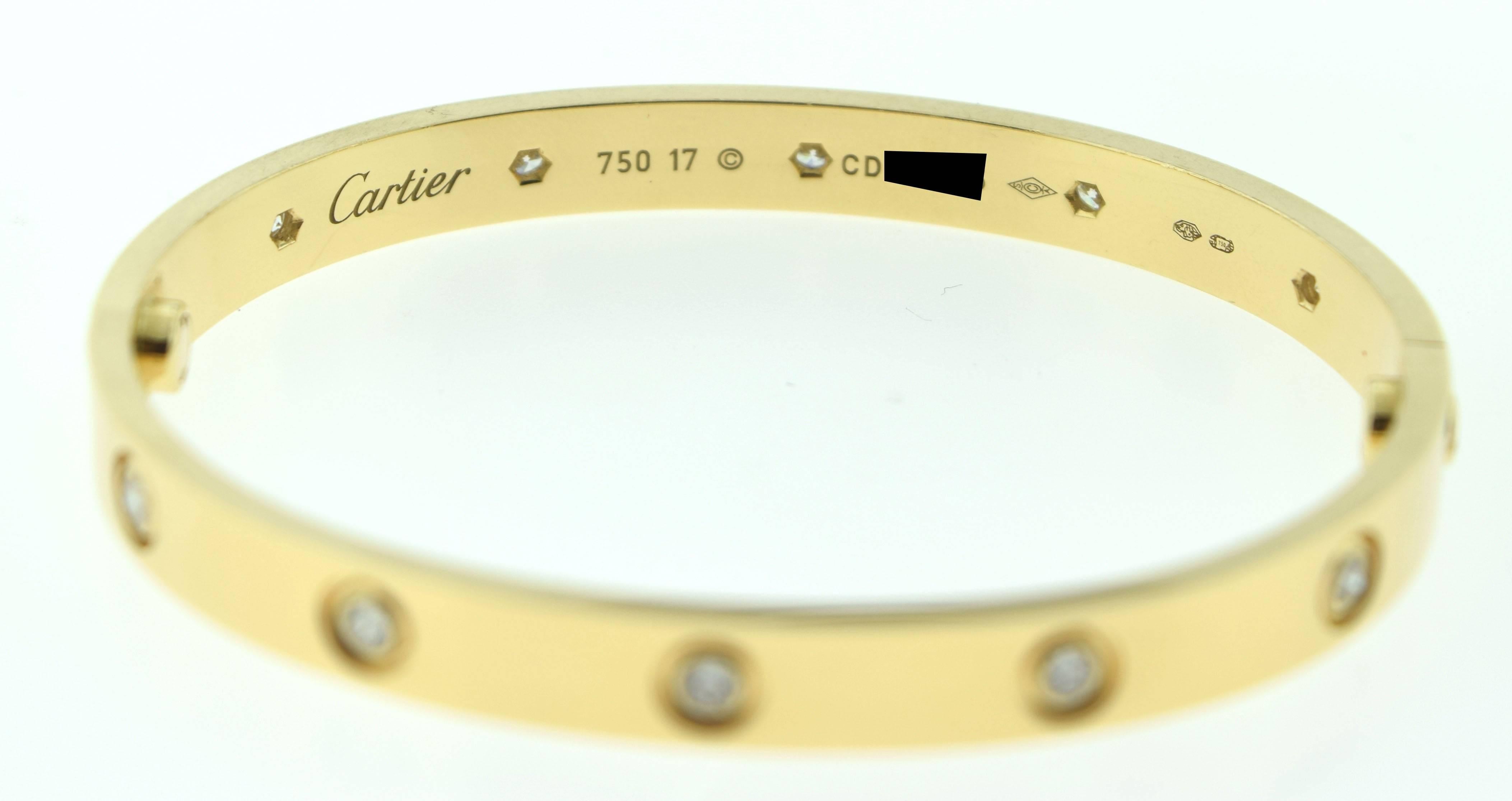 Size: 17
Brand/Designer: Cartier
Collection: LOVE
Metal: Yellow Gold
Metal Purity: 18 karat
Stones: 10 Round Brilliant Diamonds
Diamond Color / Clarity: 
Weight: 33.0 grams
Hallmark: Cartier 750 17 CD**** (Erased 4 Privacy)
Includes: Box &