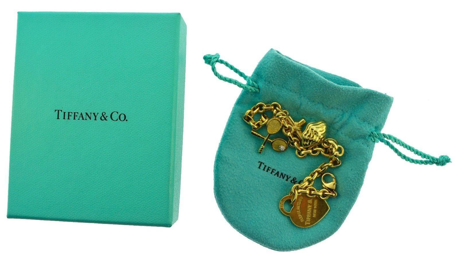 Designer: Tiffany & Co.
Metal: 18k Yellow Gold
Stones: Diamond on Racquet Charm,
Cultured Pearl in Oyster 
(enamel finish)
Total Item Weight (grams): 37.4 grams
Total Length: 7 inches
Includes: Box

With this popular Tiffany motif, one is