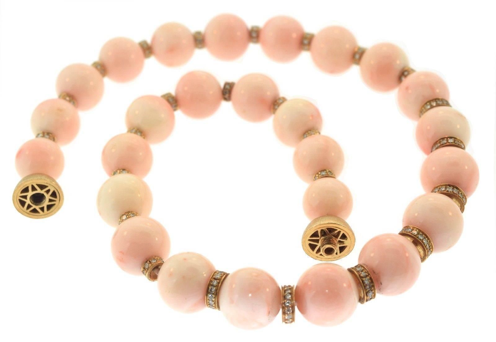 A gorgeous strand of 14 mm carved angel skin coral beads and 18k yellow gold, accented with beautiful  diamonds, weighting an estimated total 3.2 carats; fitted with a magnificent 18k yellow gold clasp.

Metal: 18k of Yellow Gold
Stone: Angel