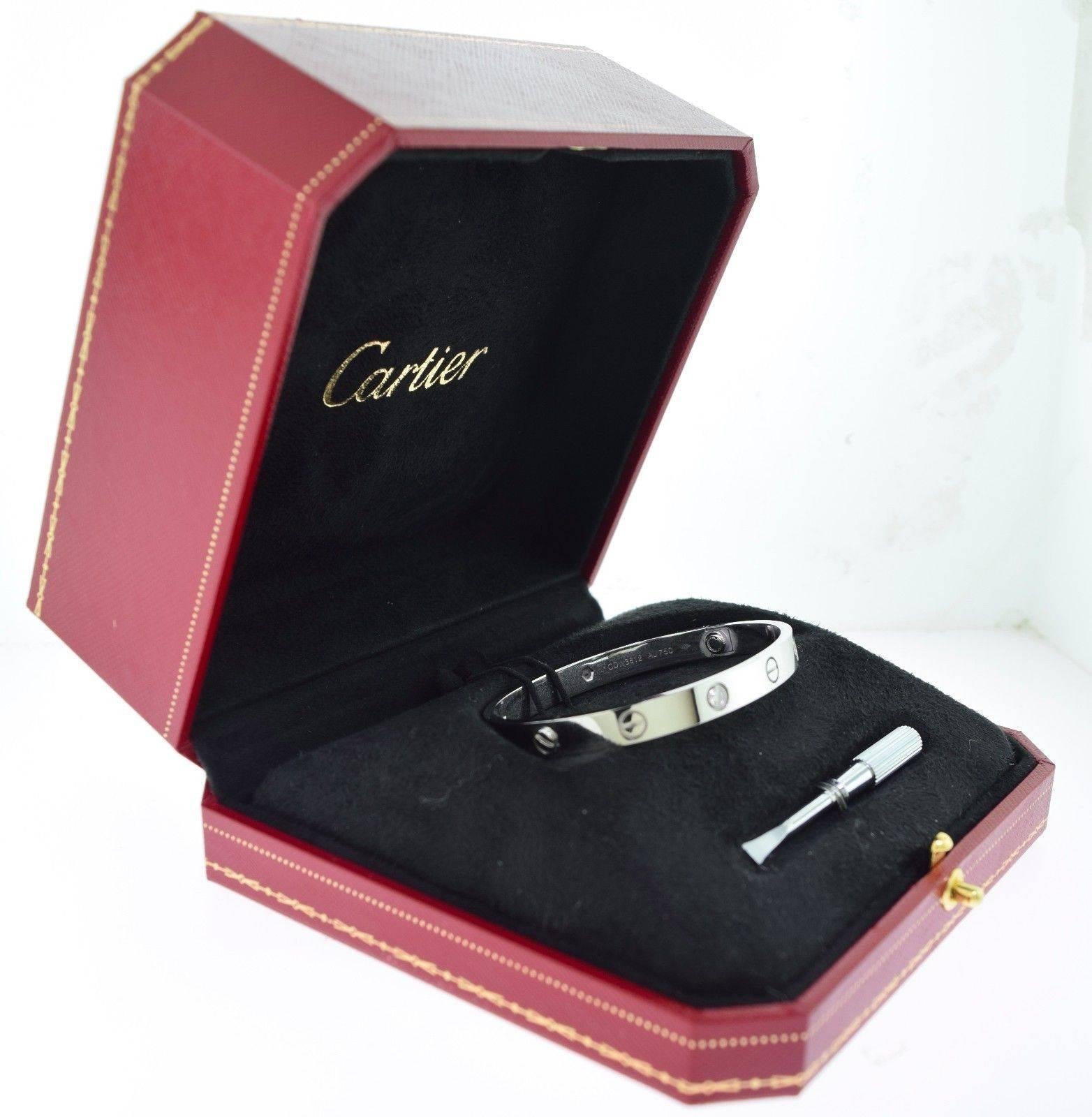 Brand: Cartier
Series: Love
Metal: 18k White Gold
Stones: 4 Brilliant Cut Round Diamonds
Size: 17
Item Weight: 31.2 grams
Screw: New Screw
Hallmark: Cartier 750 17  Serial Number

Item includes Box & Screwdriver