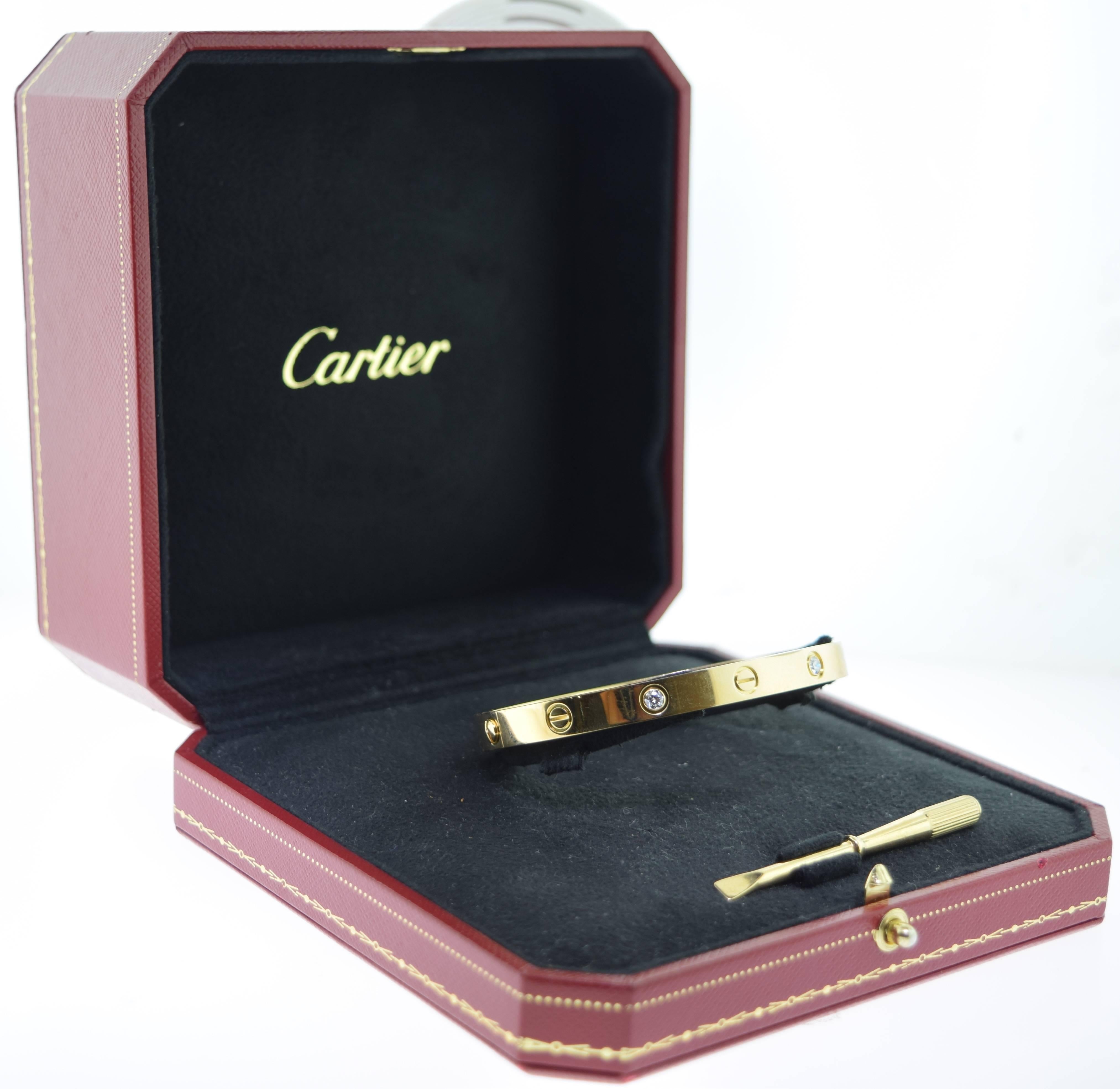 Designer: Cartier
Collection: LØVE
Metal: 18k Yellow Gold
Stones: 4 Brilliant Cut Round Diamonds
Size: 18
Total Item Weight (grams): 32.2
Screw: Old Screw
Hallmark: Cartier 750 18  ***Unique Serial Number***
Includes: Box