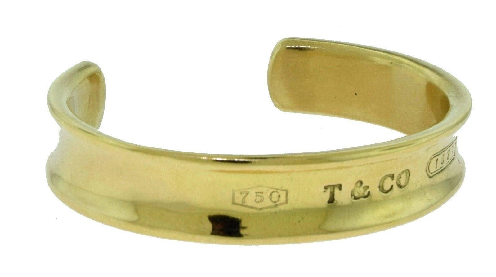 Designer: Tiffany & Co.
Metal: Yellow Gold
Metal Purity: 18k
 
Total Item Weight (grams): 51.6
Width: 11.2 mm / 0.44 inches
Side to Side Measurement: 2.01 inches
 
Hallmark: 1997, 750, T & CO, 1837
Signature: Tiffany & Co.