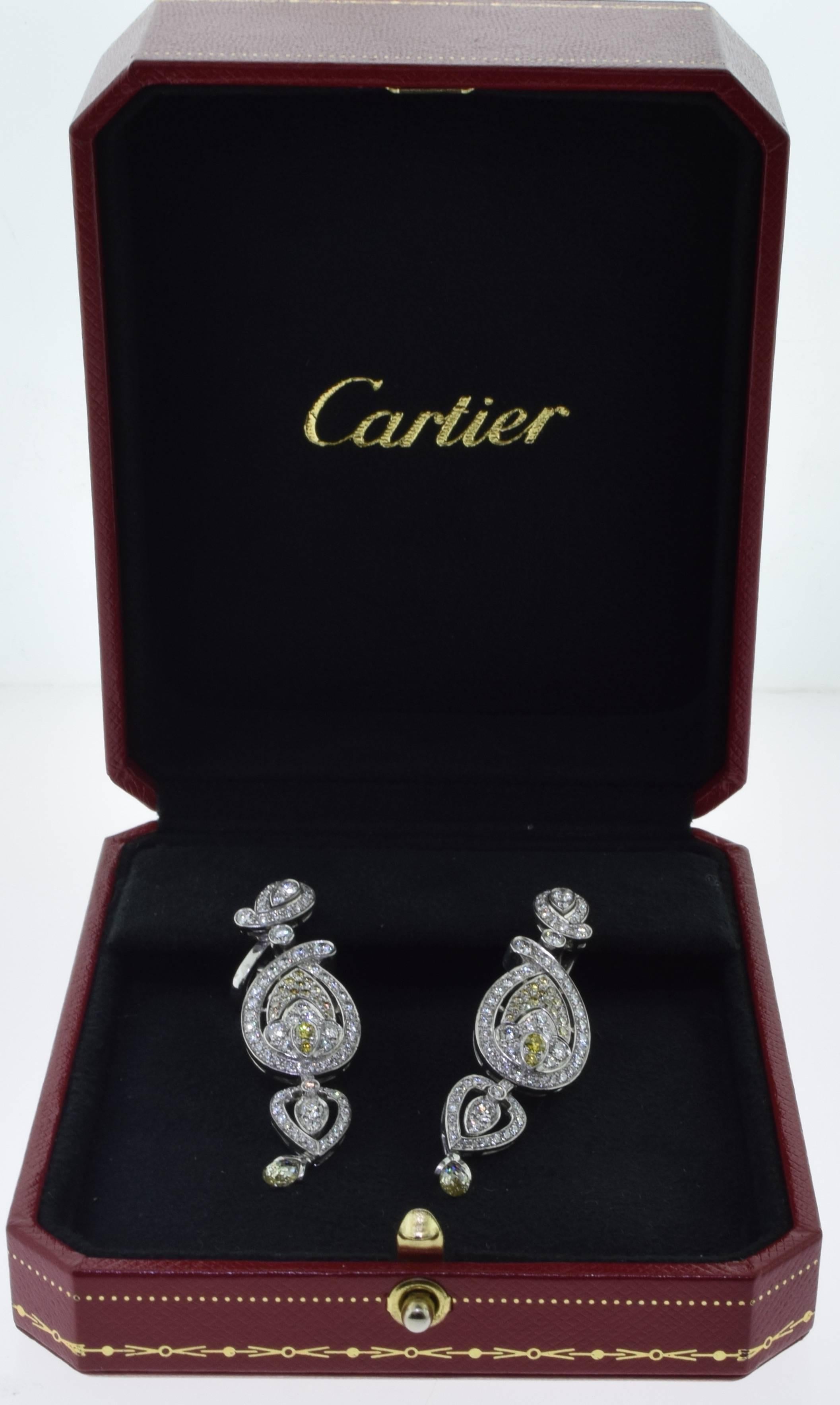 DESIGNER: Cartier
METAL: Platinum
STONES: Yellow and White Diamonds
TOTAL CARAT WEIGHT: 10 carat
TOTAL ITEM WEIGHT (grams): 25.85
LENGTH: 2.05"

SIGNATURE / HALLMARK: Cartier, Serial Number Pt950

INCLUDES: Cartier Service Paperwork

