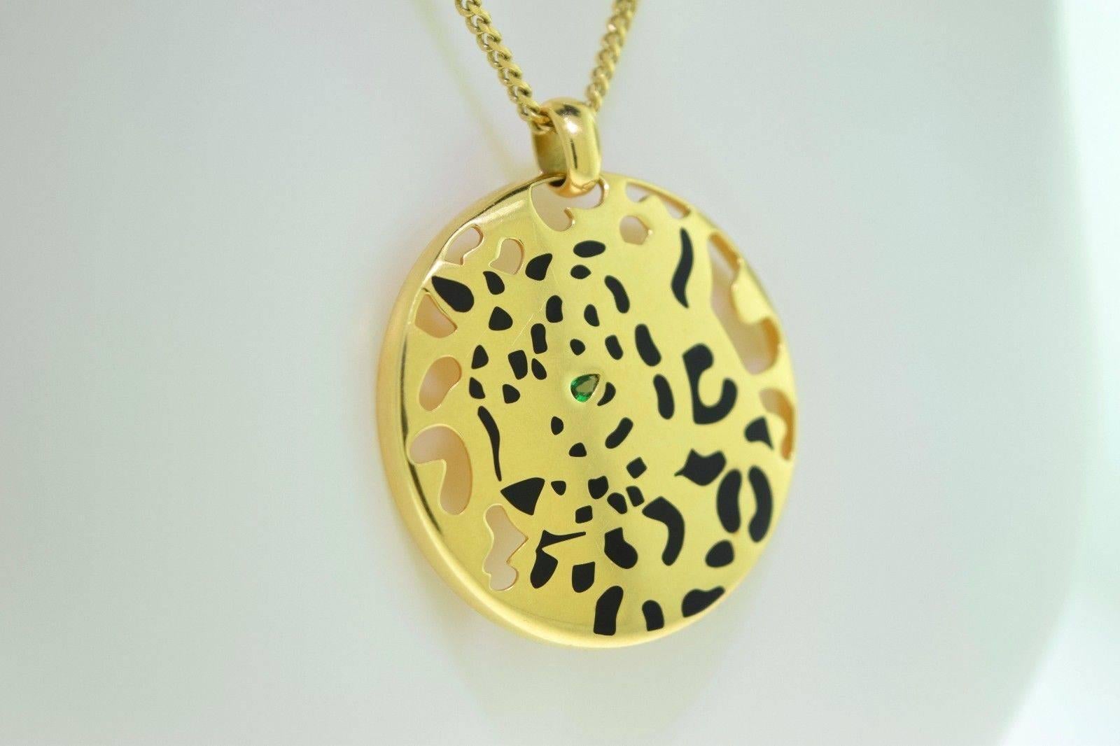 ABOUT THE ITEM:
Stunning 18k yellow gold round pendant of the signature Cartier Panther's head with black enamel spots and pear shaped emerald eye.

Item Specifications:
DESIGNER: Cartier
COLLECTION: Panthère de Cartier
METAL: Yellow Gold
METAL