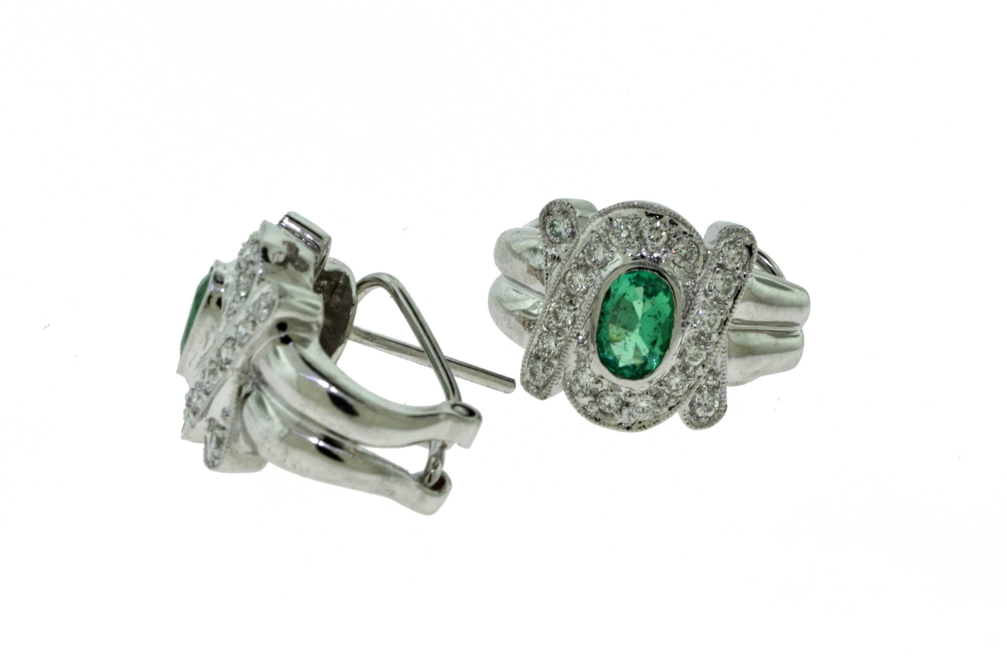 Metal: White Gold
Metal Purity: 18k
Stones: 2 Oval Colombian Emeralds, 36 Round Brilliant Cut Diamonds (18 each earring)
Emerald Carat Weight: 1.60 carat (0.8 ct each earring)
Diamond Carat Weight: 1.20 carat (0.6 ct each earring)
Diamond Color: H -