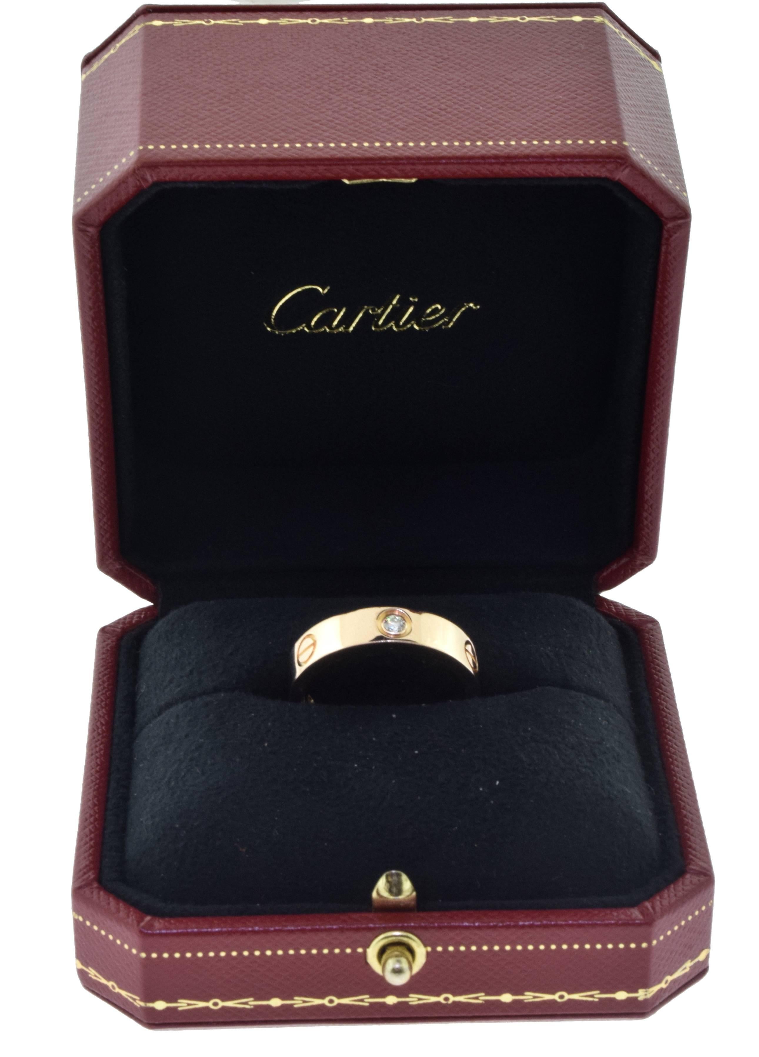 From Cartier's Love Collection:

Ring Size: 62 (euro) ; 10 (US)
Metal: 18 Karat Rose Gold
Stones: 3 Diamonds​​​​​​​
Stone Type: Round Brilliant Cut
Total Item Weight (g): 9.9
Hallmark: Cartier 750 62  Serial No.

Comes with Box, Cert. of