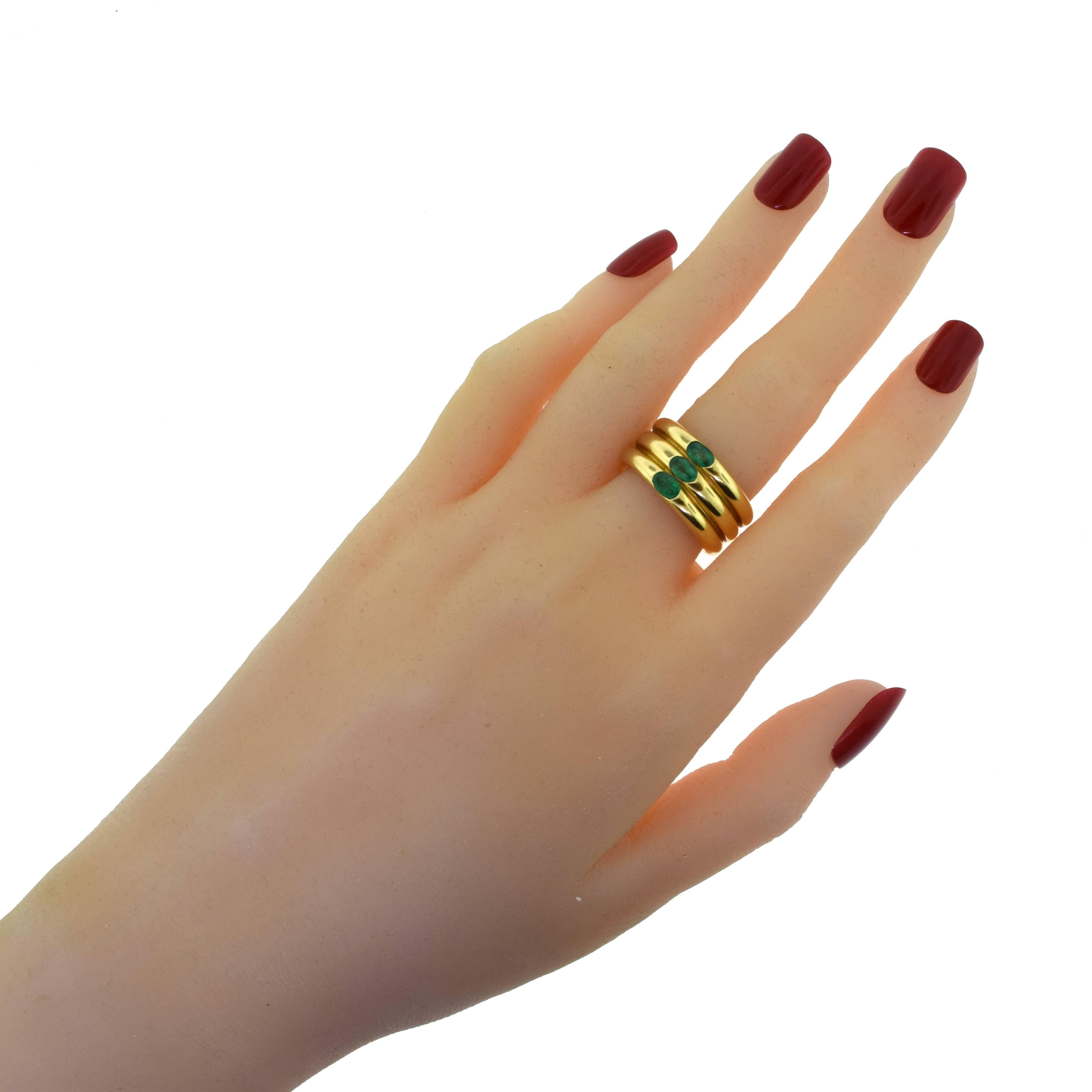 Vintage Cartier Yellow Gold Ellipsed Three Band Fused Three Emerald Ring In Excellent Condition In Miami, FL