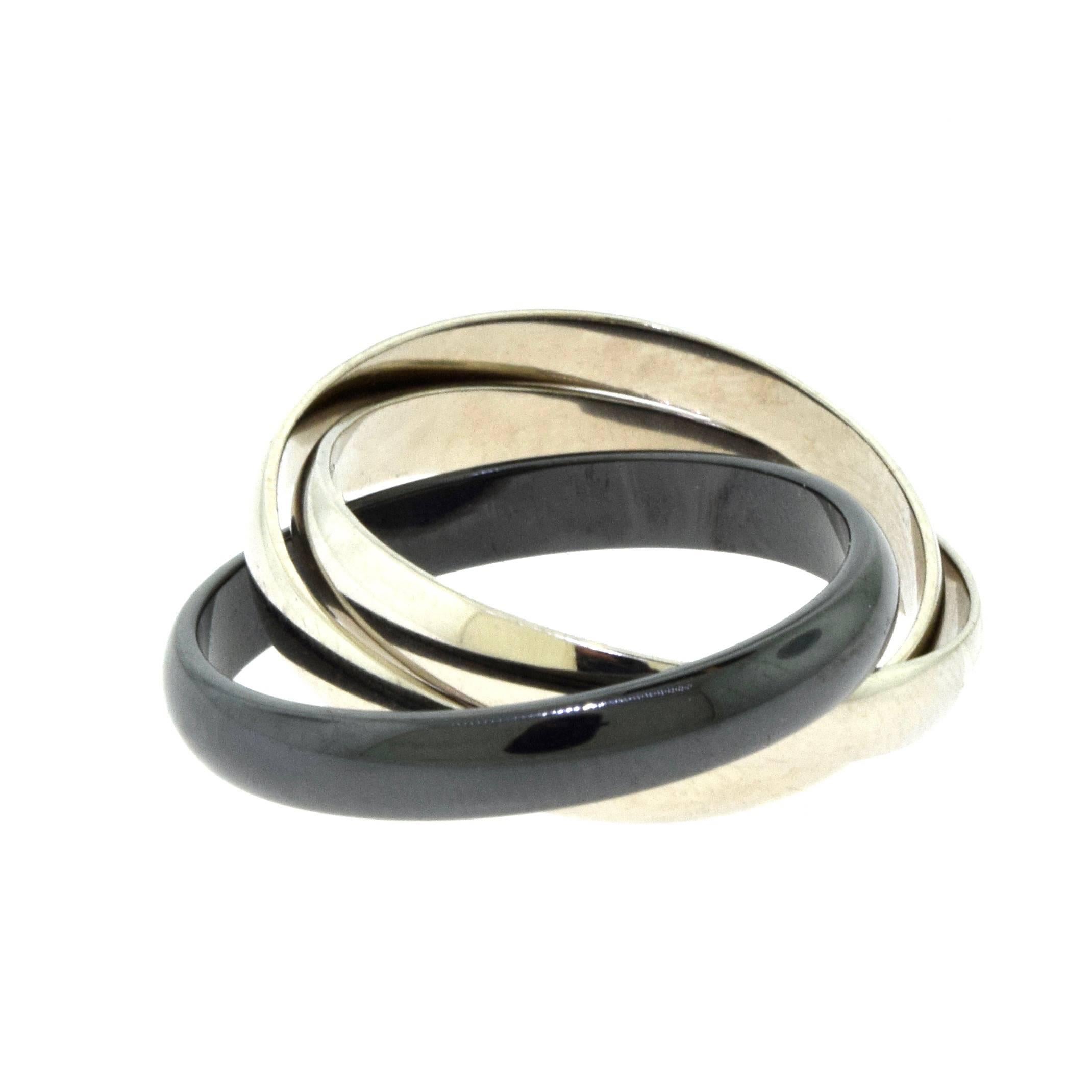 Designer: Cartier
Collection: Trinity de Cartier
​​​​​​​Ring Size: 62 (euro) ; 10 (US)
Metal: White Gold
Metal Purity: 18k 
Non-Metal Material: Black Ceramic
Total Item Weight (g): 7.7
Band Width: 3.53 mm
Hallmark: Cartier 62 Serial No.