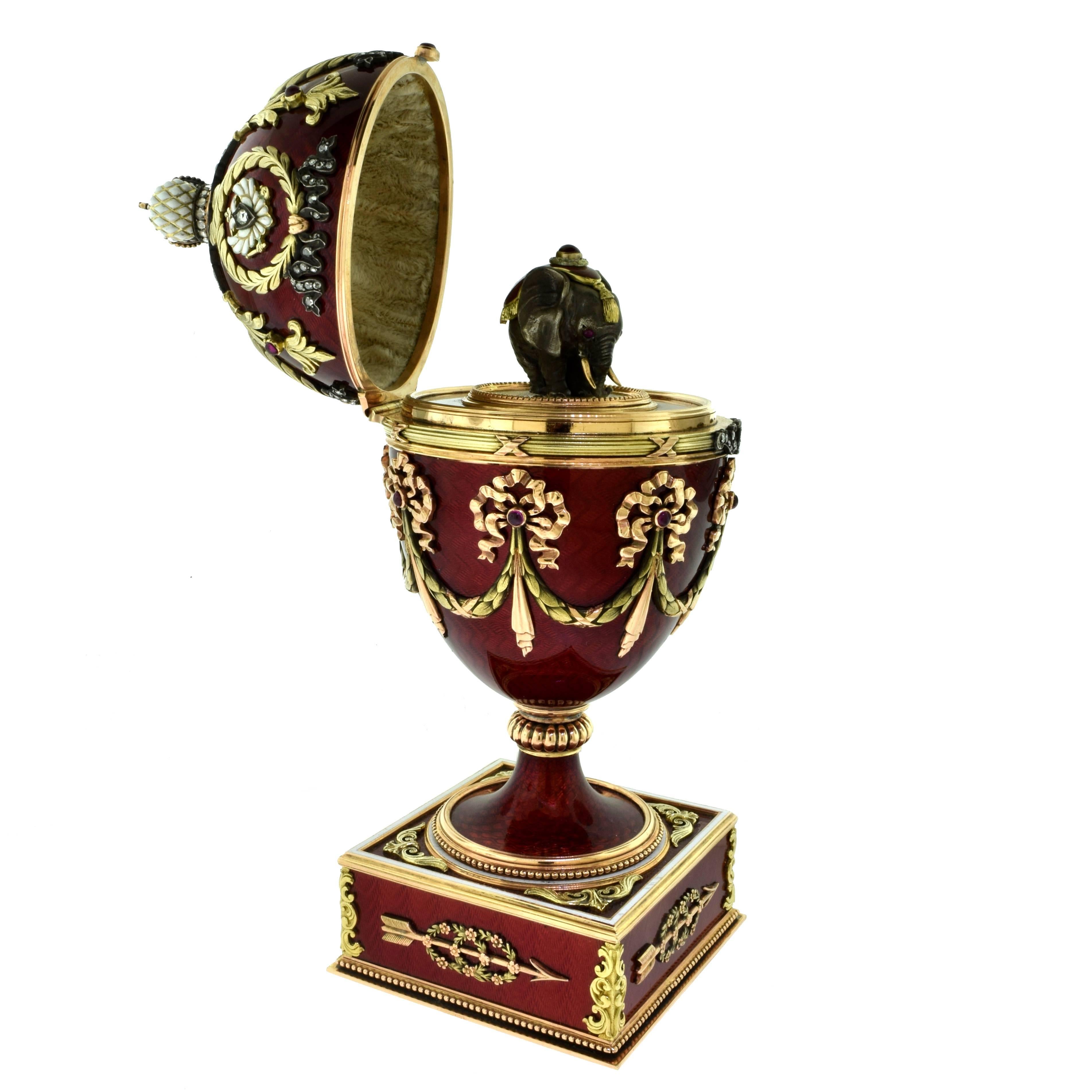 This is a magnificent Russian Huge Jeweled Gold Guilloche Egg with Diamonds, Rubies and covered in Red Enamel. The diamond and ruby thumb piece released the hinged cover to reveal a 