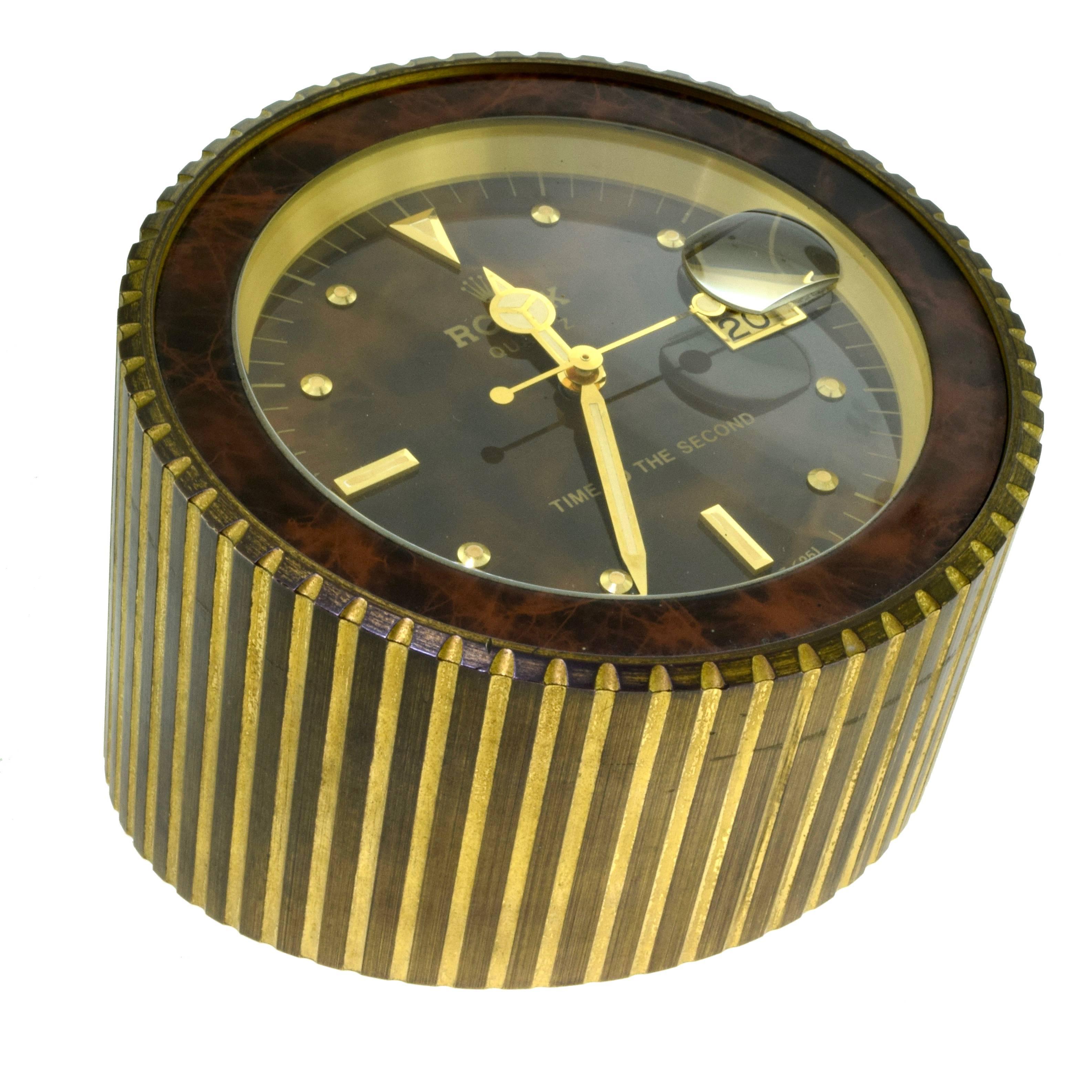 Brand: Rolex
Ref. No.: 455 
Total Item Weight (g): 2335
Diameter: 4.75 inches
Height: 2.5 " tapering up to 4 "
Battery Operated​​​​​​​

Rolex. A Gilt Metal Quartz Desk Clock with Dead Center Seconds and Date 
Signed Rolex Quartz, Time to