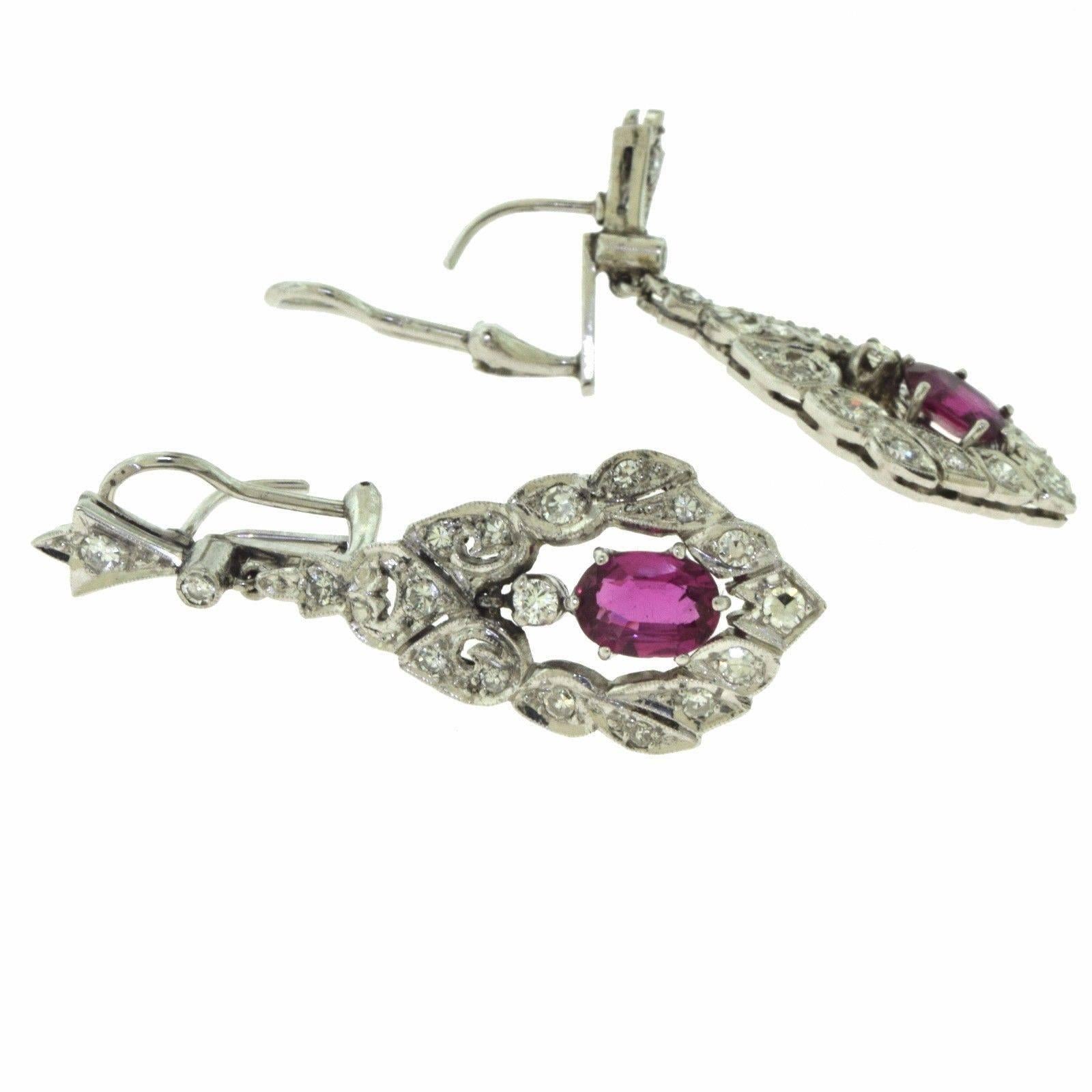 This is a magnificent pair of art deco earrings adorned with magnificent round diamonds and 2 gorgeous rubies (one on each earring) and is the result of a beautifully intricate work of art with a precious story to tell the world. This makes a