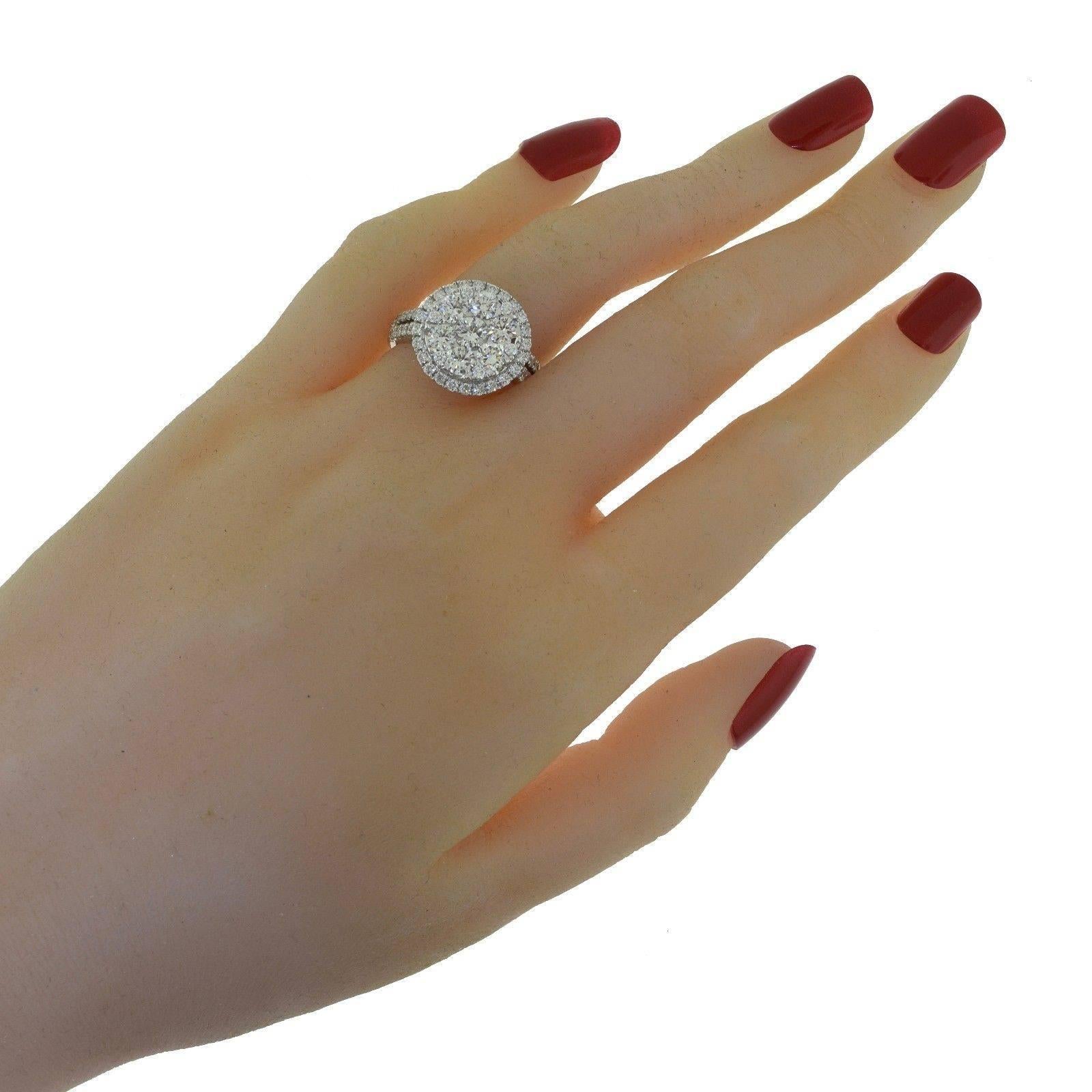 Style: Round Diamond Halo Ring 
Metal: White Gold
Metal Purity: 18k
Stones: 1 Round Center Stone Diamond = 0.30 ct ; 6 Round Center Diamonds = 1.06 ct ; 54 Small Round Diamonds = 0.84 ct
Diamond Color: F
Diamond Clarity: VVS
Total Carat Weight: 2.24