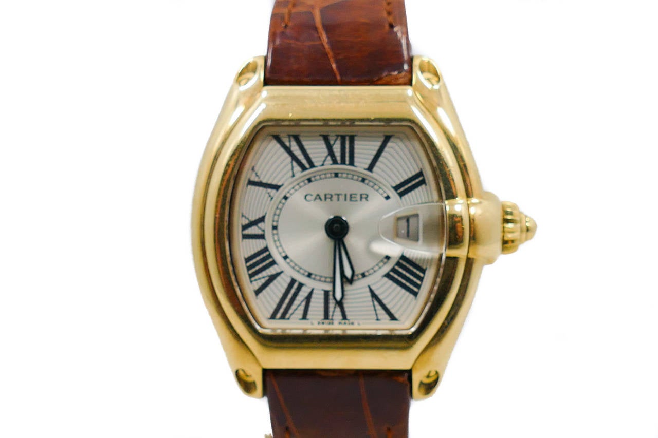 Ladies Cartier Roadster in 18k Yellow Gold on Leather Strap.  The Watch Features a Battery Operated Movement.