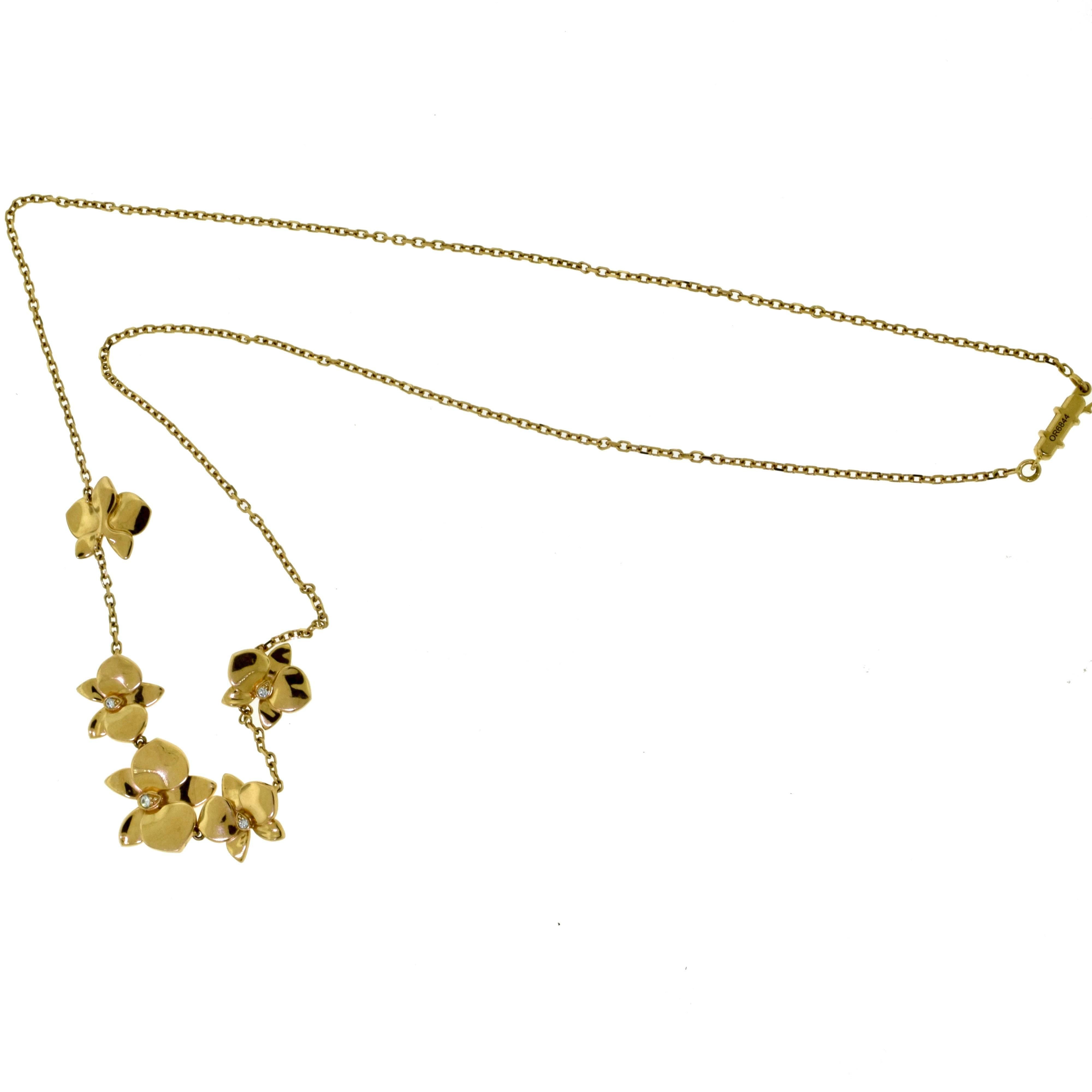 Designer: Cartier
Collection: Caresse d'Orchidees
Metal: Rose Gold
Metal Purity: 18k
Stones: 5 Round Brilliant Cut Diamonds 
Necklace Length: 21.5 inches
Total Item Weight (g): 17
Hallmark: Cartier 750 Serial No.

A popular flower at Cartier, the