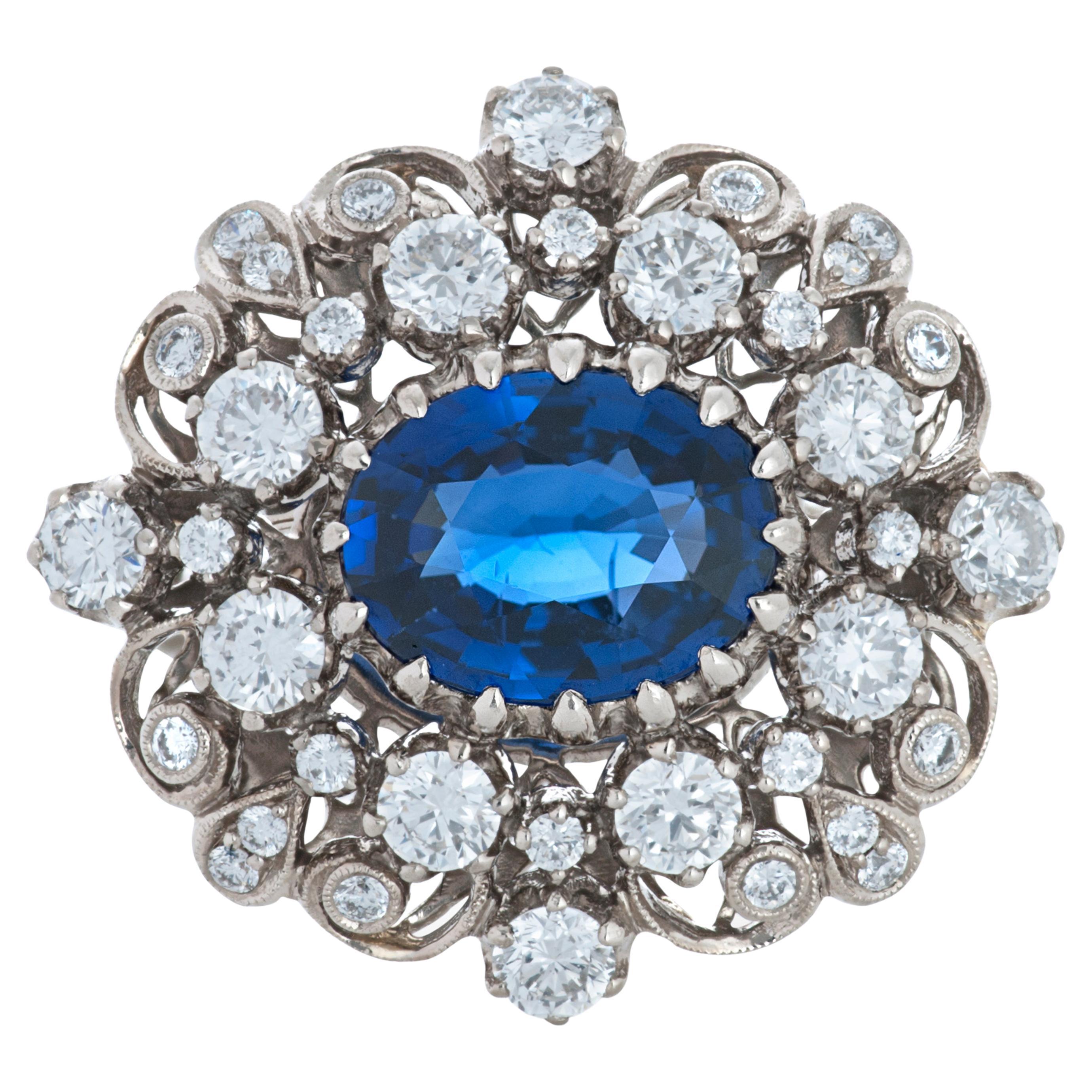 Kwiat Vintage Collection Art Deco style sapphire and diamond 18k white gold ring.  

The center stone of this ring is a 2.00 carat oval sapphire surrounded by 36 round diamonds totaling approximately 1.00 carat with estimated G-H color and VS