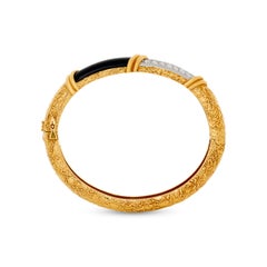 Bracelet manchette Van Cleef & Arpels en or 18 carats et platine, avec onyx noir et diamants