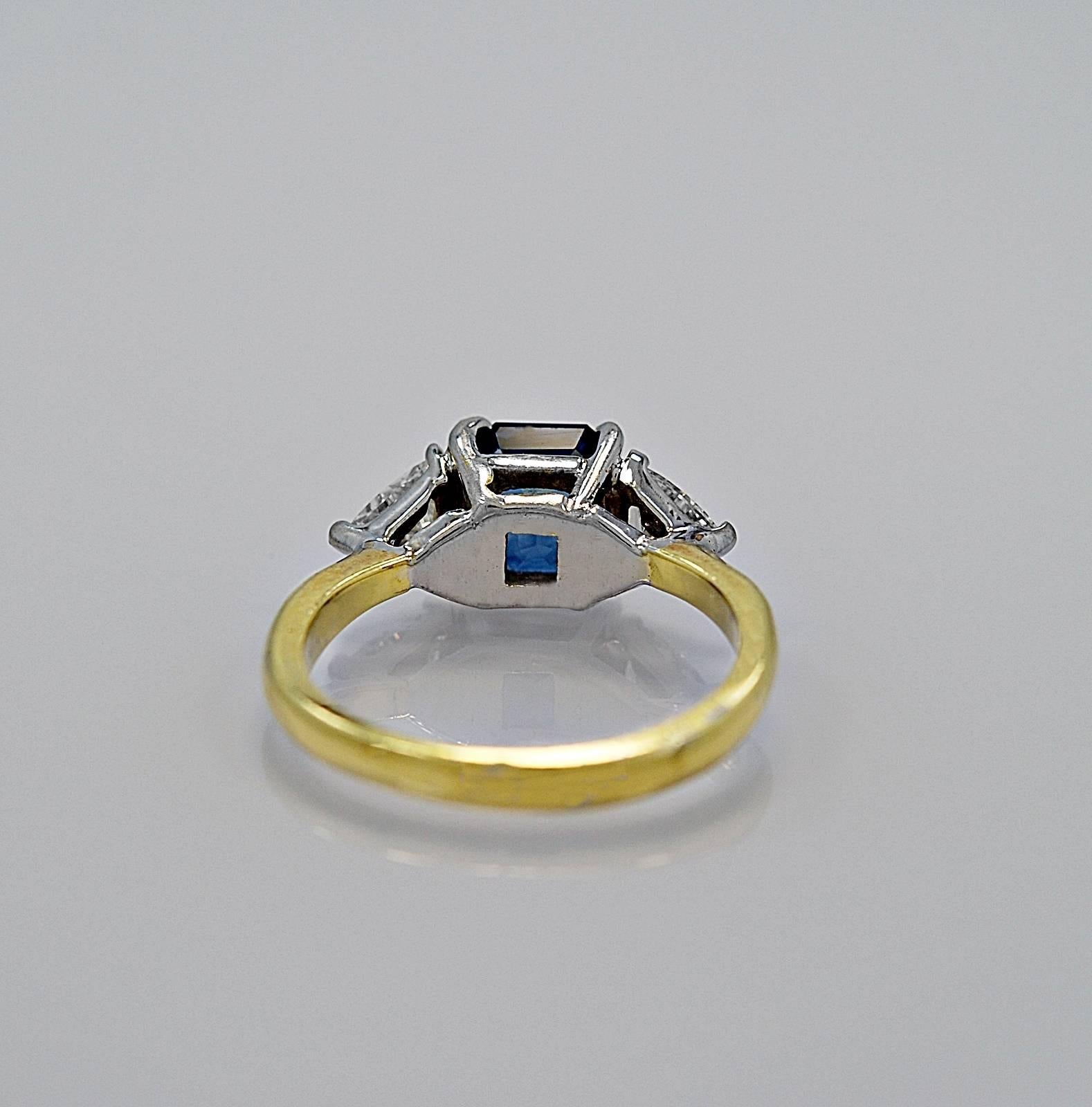 In our Tampa store this item has a retail price of $8,995.

A traditional 18K white/yellow gold sapphire & diamond ring, c. 1950's, features a 1.50ct. apx. medium blue sapphire and two trillion cut diamonds weighing .60ct. apx. each. The diamonds