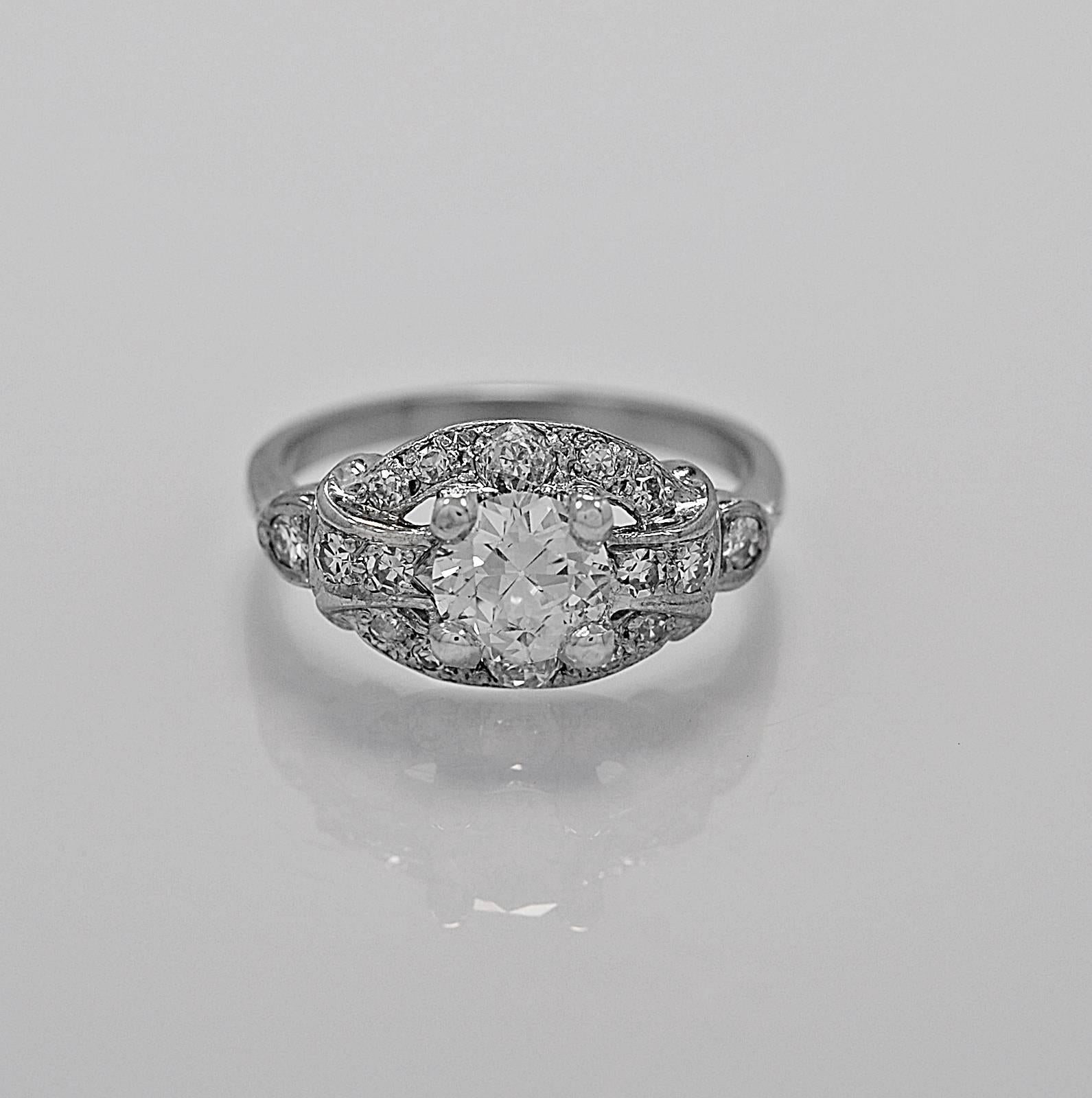 A sparkling antique engagement ring featuring a .77ct. apx. European cut center diamond with SI1 clarity and G-H color. The .50ct. apx. T.W. of single cut and European cut melee diamonds surround the center diamond. This Art Deco engagement ring is