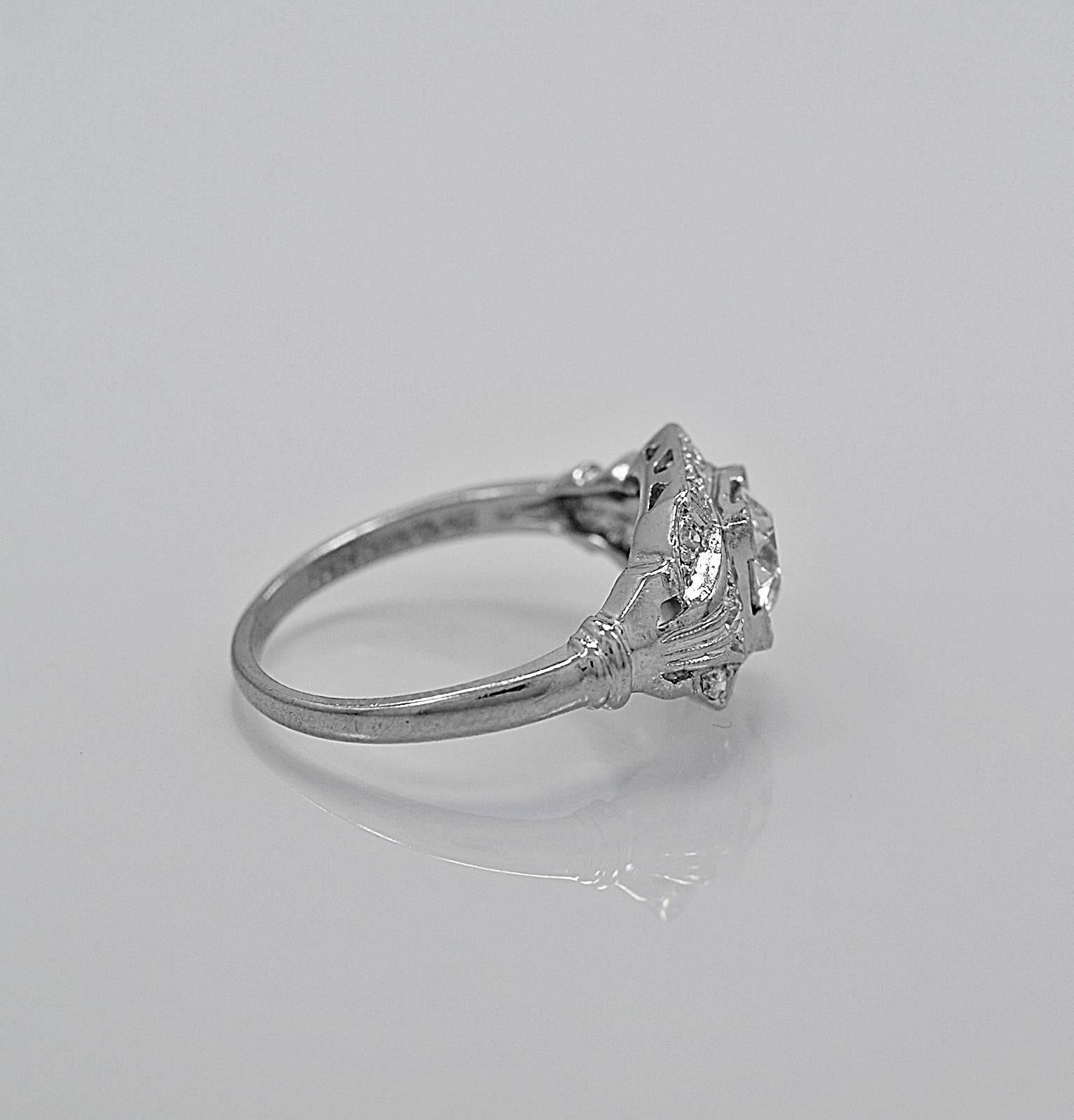 A superior quality antique engagement ring crafted in platinum featuring a .70ct. apx. European cut diamond of VS1 clarity and K-L color. The accenting .25ct. apx. T.W. of diamond melee highlights the center diamond beautifully. This is an overall