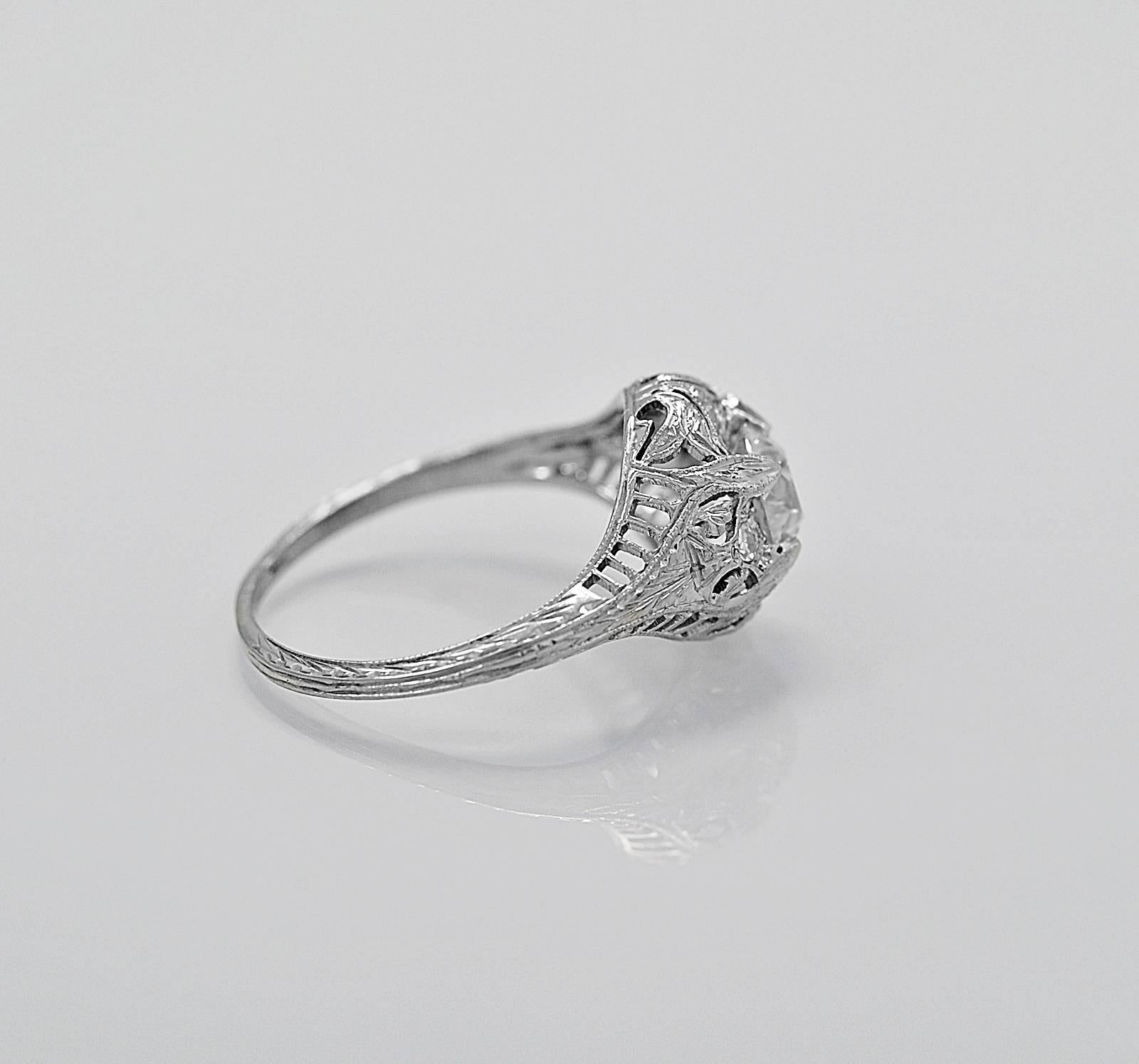 A wonderful antique engagement ring crafted in platinum that features a .66ct. apx. European cut center diamond with VS1 clarity and F-G color. The mounting is meticulously filigreed. It is a stunning and masterful piece of art! 

Primary
