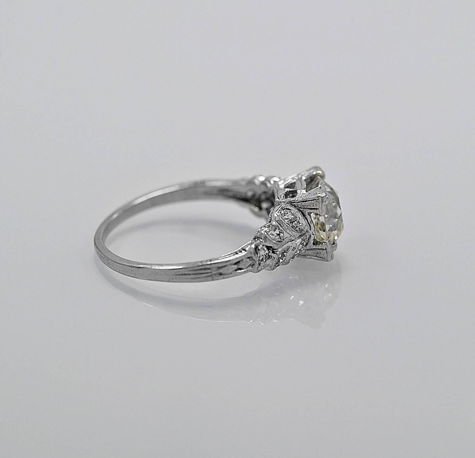 This is a beautiful antique engagement ring, one of the most desireable looks in our store. It features a dazzling 1.35ct. apx. European cut center stone with SI3 clarity (100% eye clean) and K-L color. The diamond has extraordinary life and