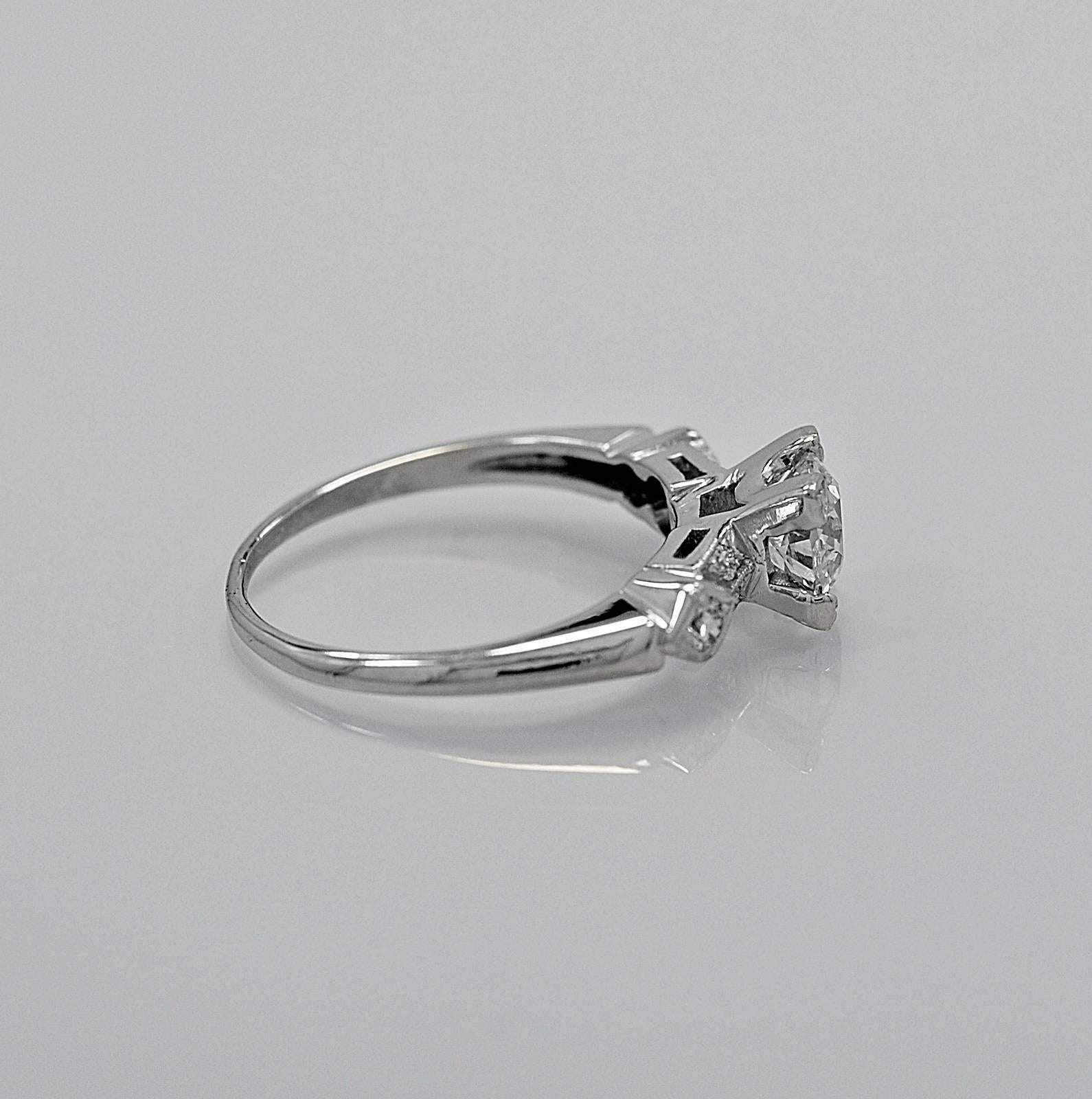 This lovely antique engagement ring features a .75ct. apx. European cut center diamond with unique triangular prongs. The clarity is SI3 (100% eye clean) with J color. The accenting .18ct. apx. T.W. of transitional cut diamonds are VS2-SI1 in