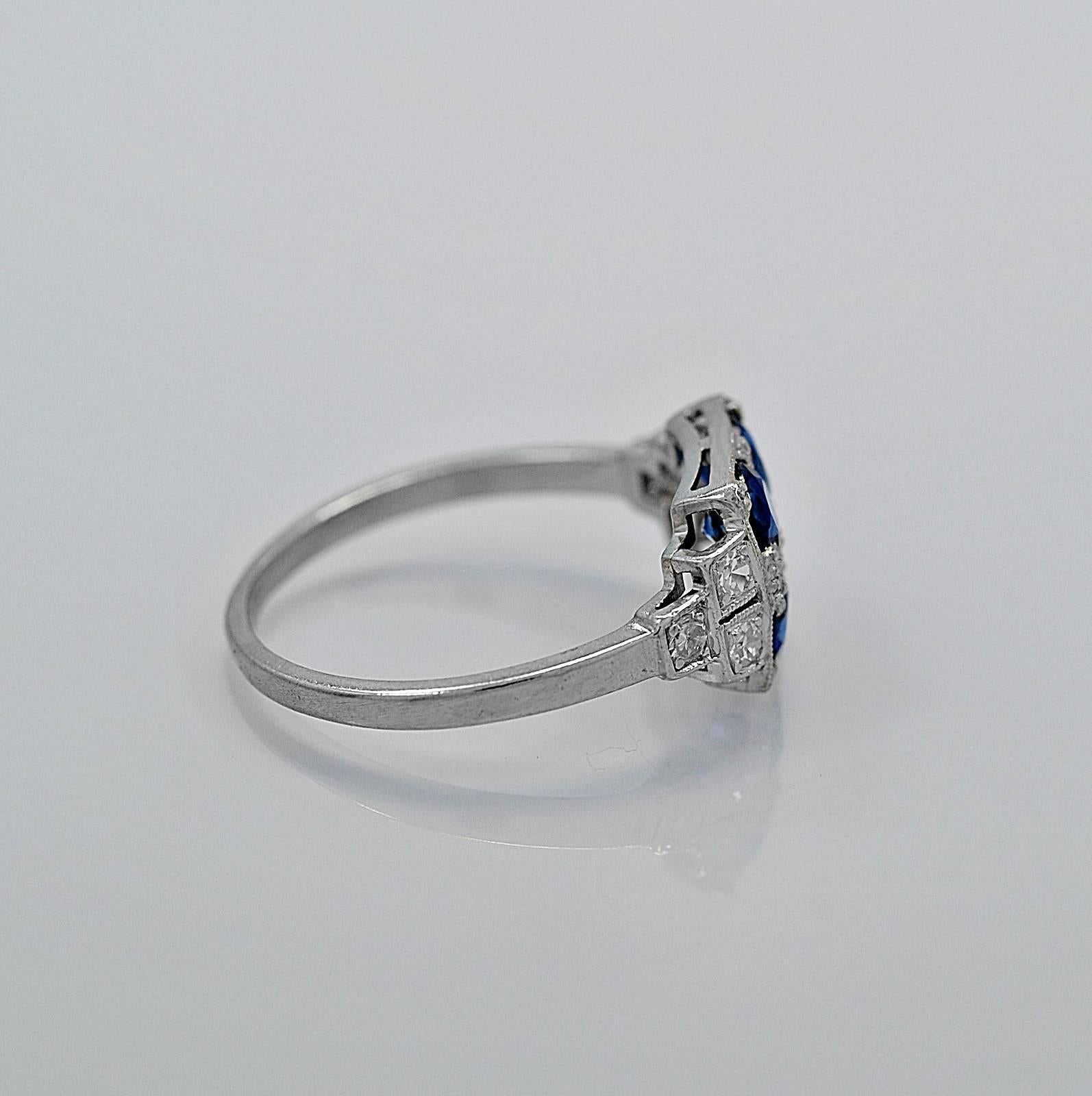 A uniquely designed antique engagement ring or fashion ring featuring 4 rich blue sapphires that weigh 1.25ct. apx. T.W. set into a square and decorated head with diamonds and milgrain. Additionally, there are 3 diamonds on each side, east to west,