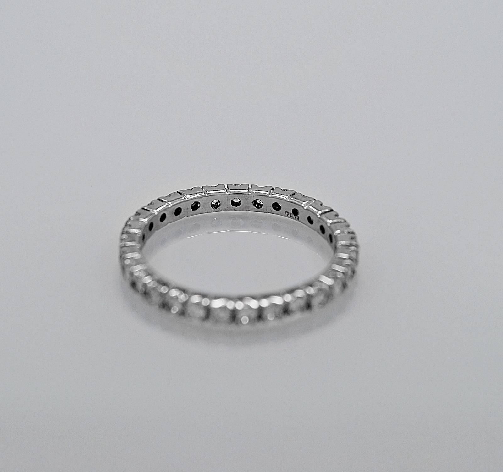 A classic estate wedding band featuring .75ct. apx. T.W. of round brilliant diamonds. This beautiful prong set diamond eternity band would look lovely with any engagement ring or as a stand alone wedding band. Traditional and elegant!

Primary