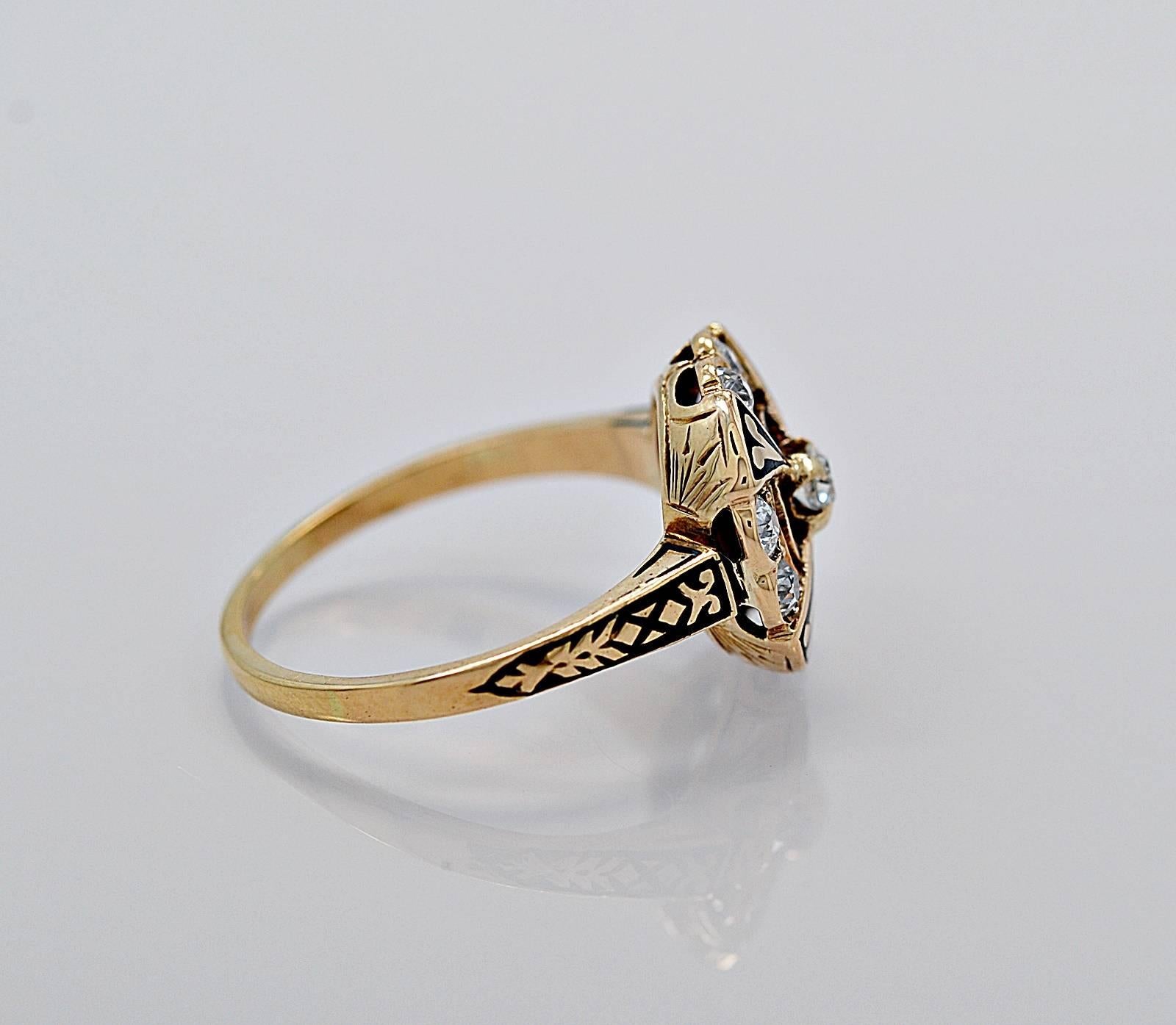 A unique antique engagement ring or fashion ring crafted in 14K yellow gold with enamel accents. This ring features a .10ct. apx. European cut center diamond that is surrounded by .50ct. apx. T.W. of exceptional quality diamonds with VS2-SI1 clarity