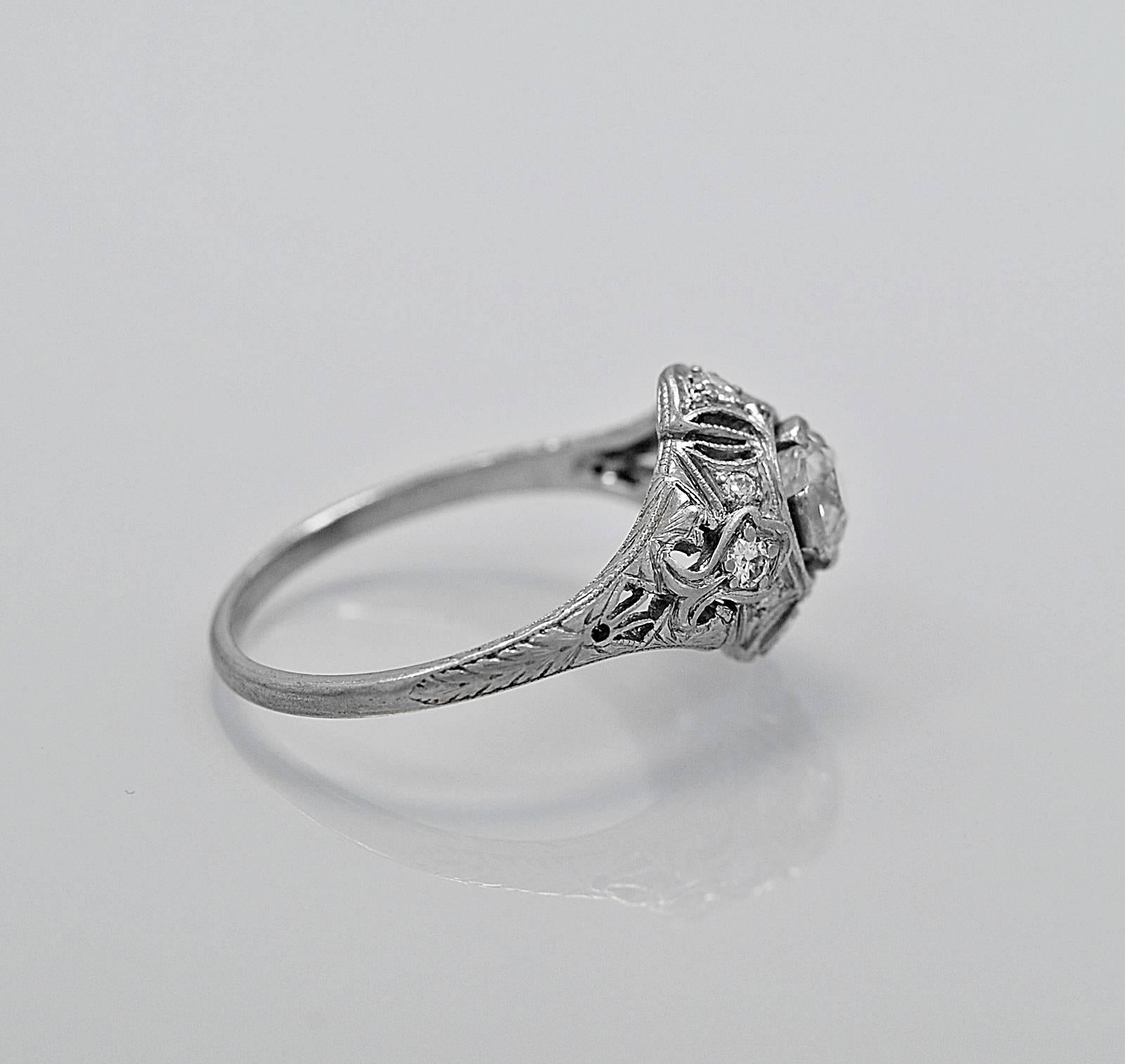 An Art Deco platinum and diamond antique engagement ring or fashion ring featuring a lovely .74ct. apx. center diamond of VS2 clarity and G-H color. The accenting diamonds are .16ct. apx. T.W. and are also fabulous quality. The ring is exquisitely