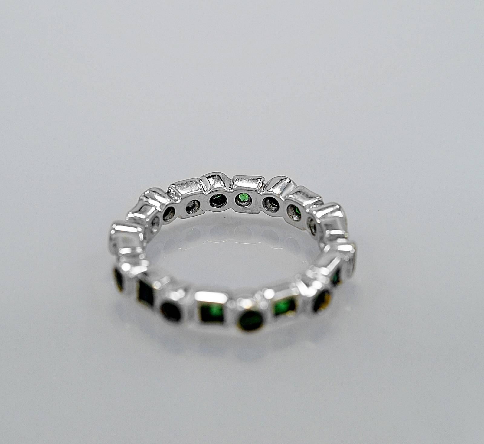 A wonderful estate wedding band featuring 1.25ct. apx. T.W. of tsavorite garnets. This is a hard to find band with a unique design. Very rare! 

Primary Stone(s): Tsavorite
Weight: 1.25 cts. apx. T.W. 
Color: Green
Clarity: VS2-SI1
Cut: Round