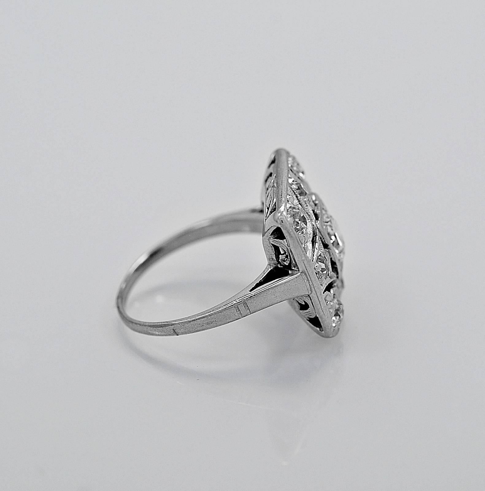 An antique engagement ring or fashion ring crafted in platinum featuring a .50ct. apx. European cut center diamond that is accented with .60ct. apx. T.W. of European and single cut diamonds. The gallery is finely filigreed. This ring would be a