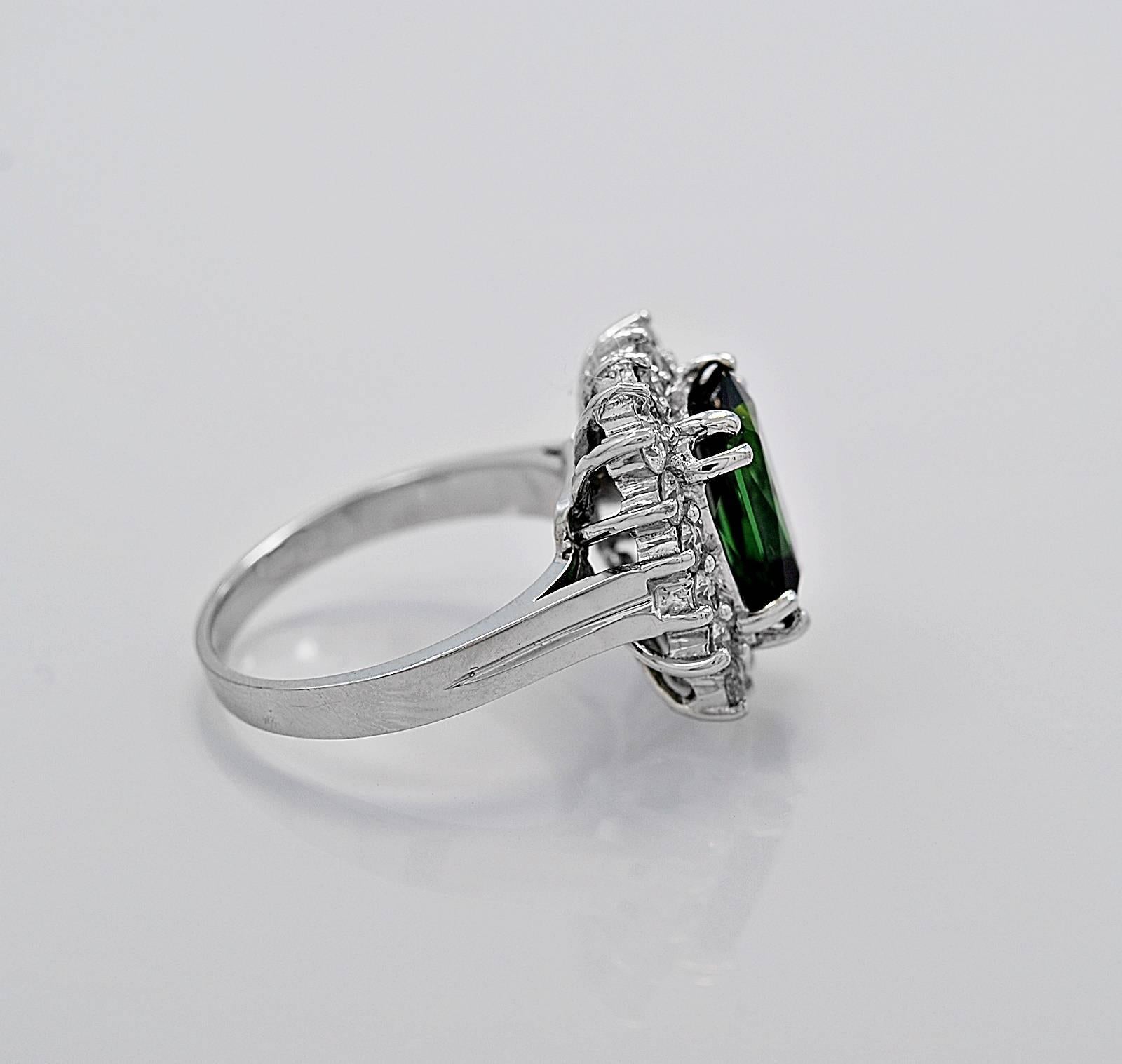 A beautiful estate fashion ring featuring a 3.50ct. apx. rectangular cushion cut tourmaline surrounded by 1.00ct. apx. T.W. of round brilliant diamonds. This impressive ring would be an excellent addition to your jewelry wardrobe!

Primary
