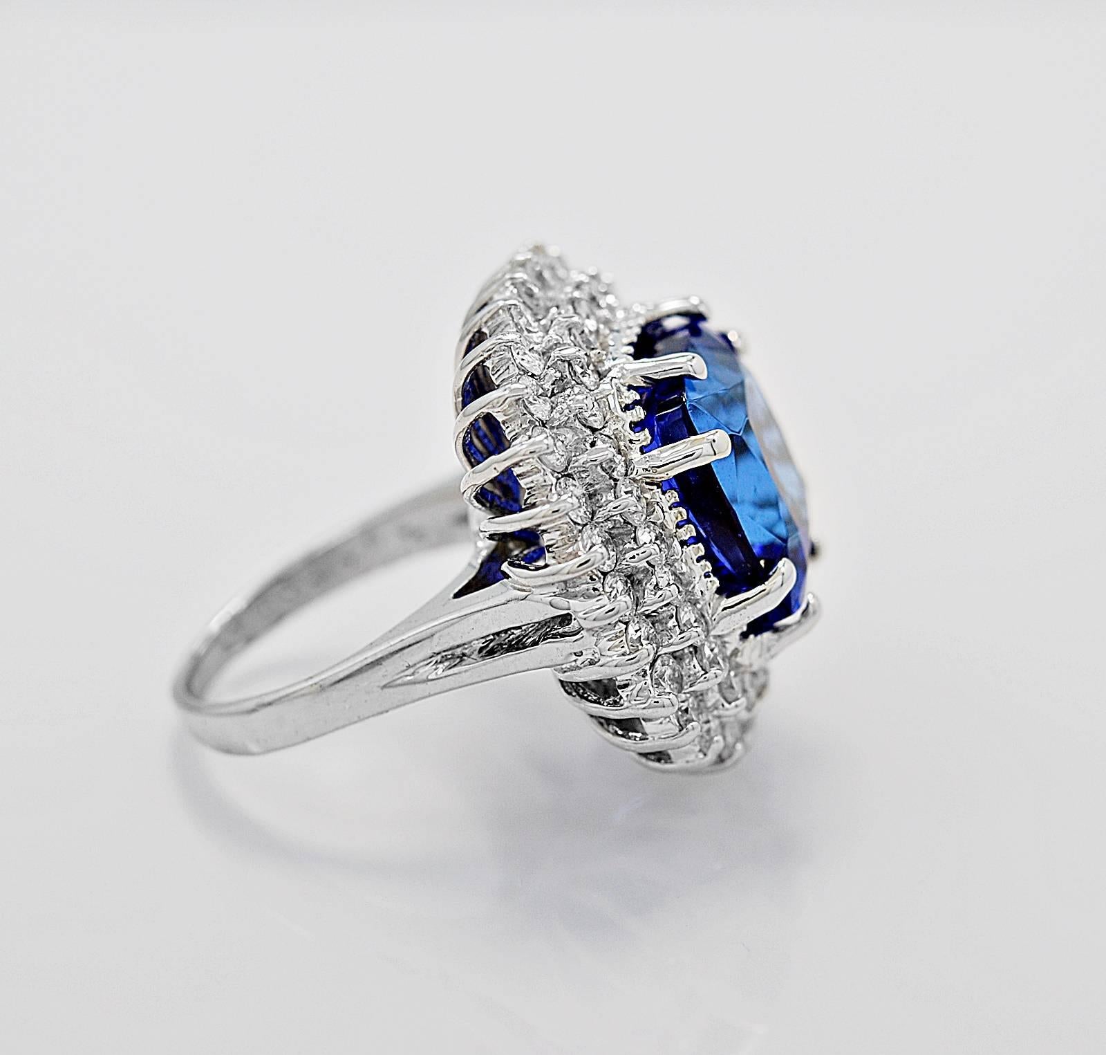 A gorgeous estate fashion ring that is a wonderfully large look. The 13.00ct. apx. tanzanite is cushion cut, beautifully eye clean, and has a wonderful intense violet bluish color! The 2.00ct. apx T.W. of round brilliant diamonds really accent this