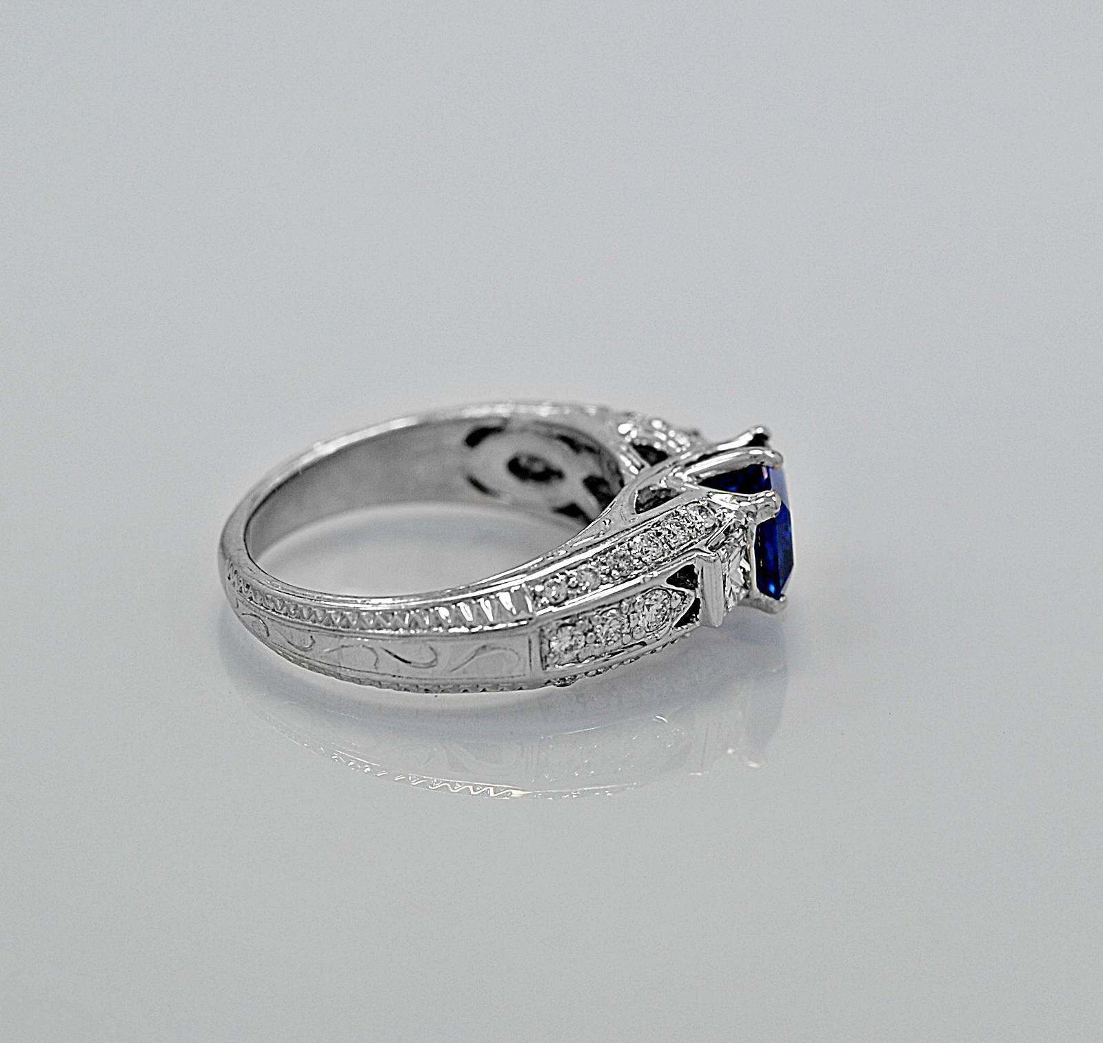 An elegant engagement ring featuring a 1.50ct. natural blue sapphire and accenting .60ct. apx. T.W. of melee diamonds with VS2-SI1 clarity and G-H color. This decorative ring with piercing and engraving is a very nice alternative to a standard