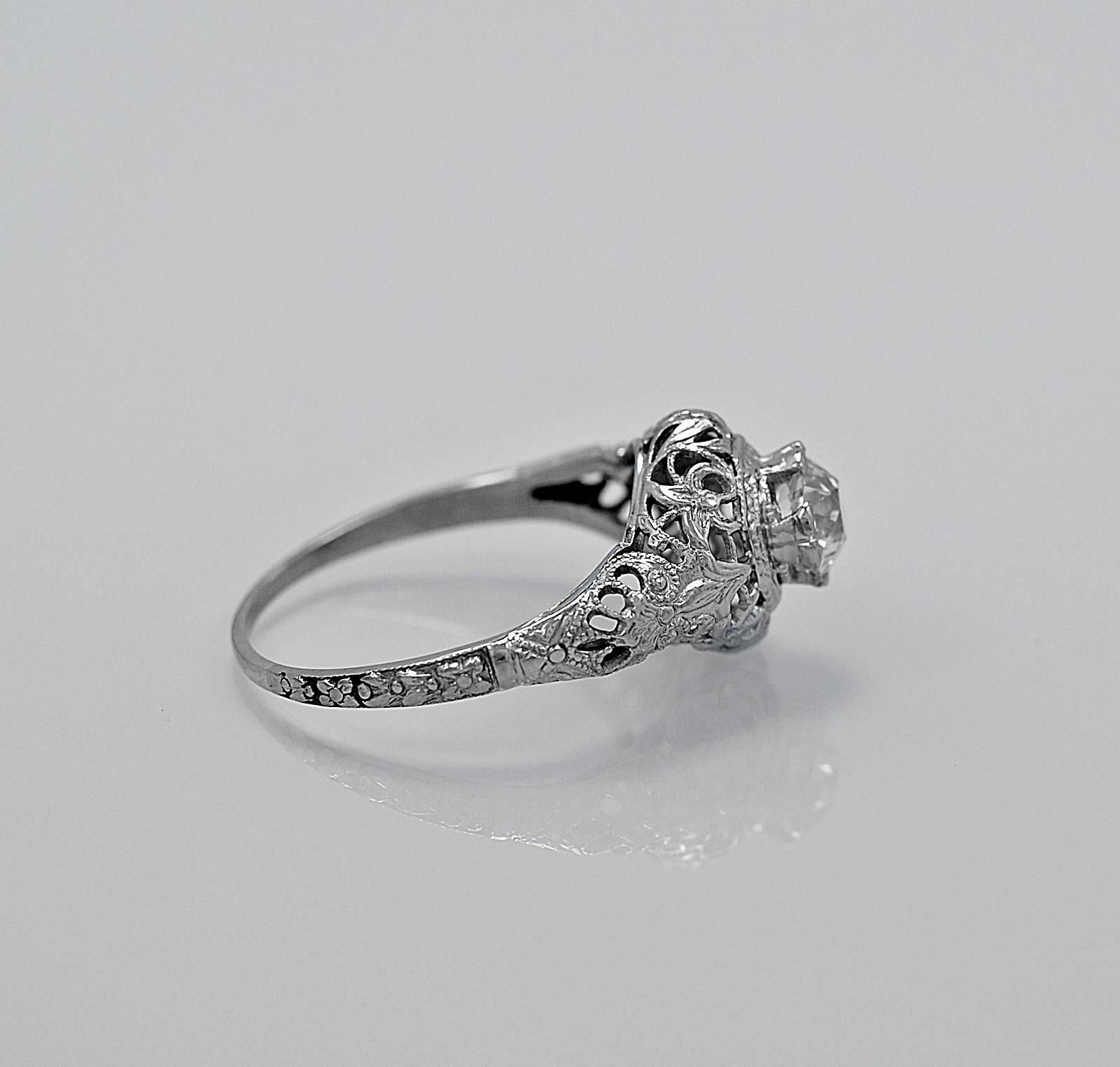 A very decorative antique engagement ring featuring a .60ct. apx. European cut diamond with SI1 clarity and J color. This timeless diamond ring is crafted with crisp filigree and engraving. Unbelievable!

Primary Stone(s): Diamond - Conflict
