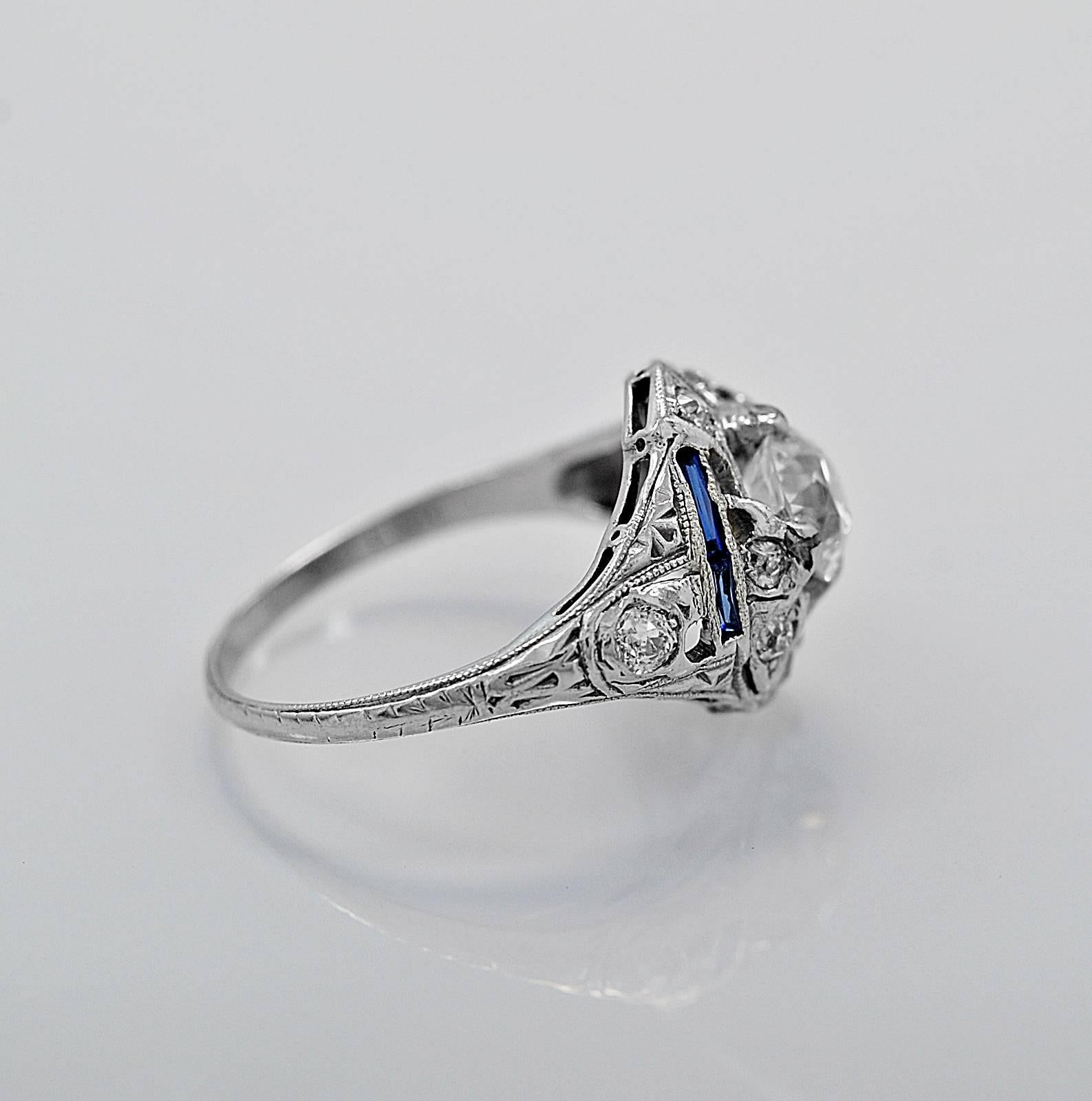 This is an absolutely beautiful antique engagement ring featuring a .82ct. apx. European cut center diamond with SI2 clarity and K color. It also has an accenting .24ct. apx. T.W. of European cut diamonds that are delicately outlined with milgrain.