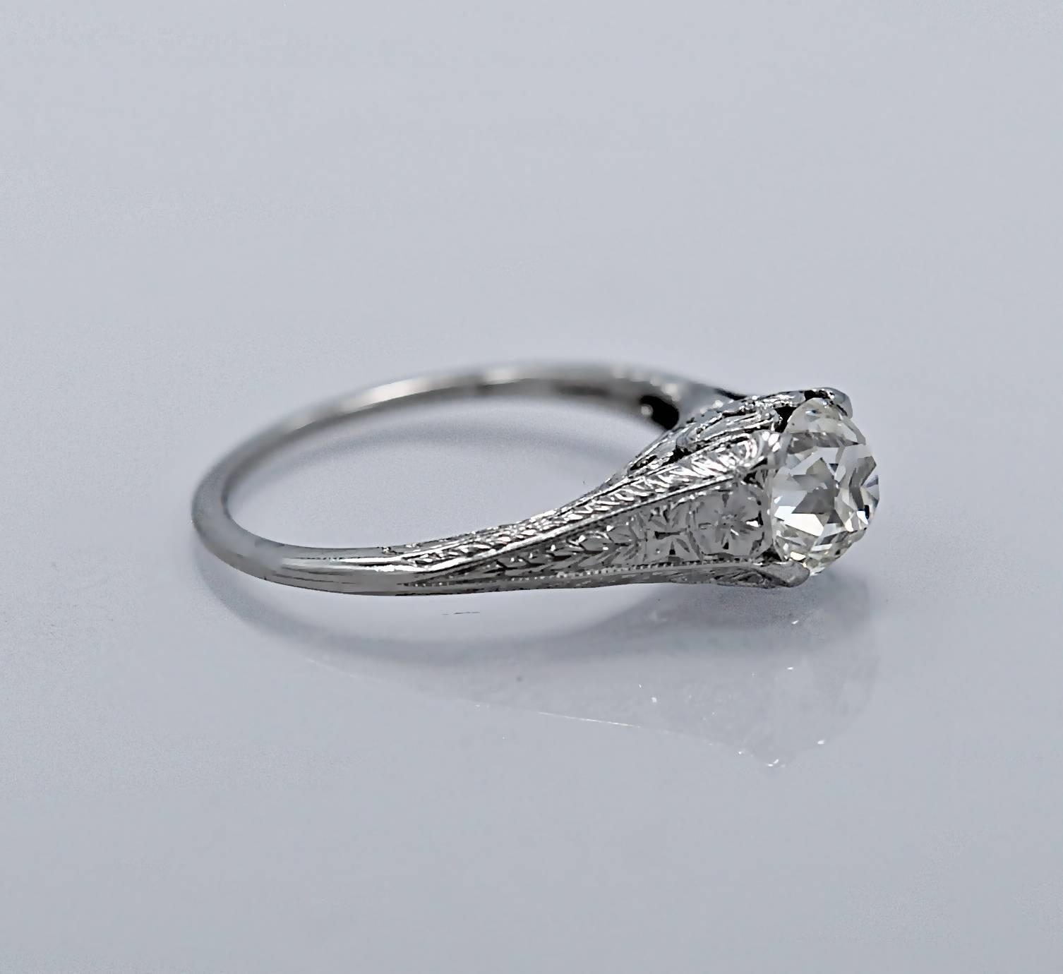 A beautifully designed Art Deco Antique engagement ring featuring a 1.20ct. apx. old mine cut diamond with I1 clarity (100% eye clean) & J color. The mounting is exceptionally made with meticulous filigree containing bows on the gallery. The