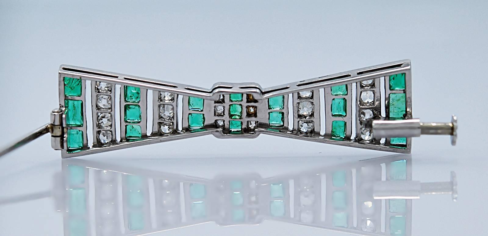 A geometrically designed emerald & diamond Antique brooch resembles a bow and features 2.00ct. apx. T.W. of rich green emeralds and 1.00ct. apx. T.W. of diamonds with VS1-VS2 clarity and G-H color. It does not get much better than this in terms