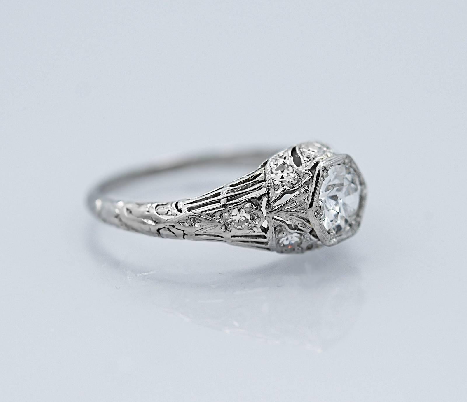 A sparkling and beautiful Platinum Art Deco diamond antique engagement ring that features a lovely .42ct. apx. European cut diamond with F color and SI1 clarity. The accenting single cut diamonds are VS1-VS2 clarity and G-H color. Lovely engraving,