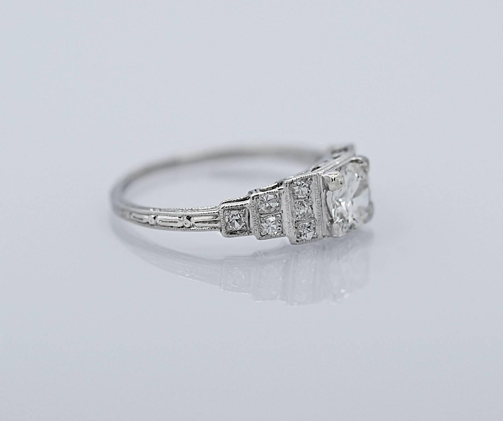 A traditional Art Deco Antique engagement ring featuring a .50ct. apx. European cut diamond with VS2 clarity and I color. The .15ct. apx. T.W. single cut diamonds, decorating the sides in a step down design, are VS2-SI1 clarity and G-H color.