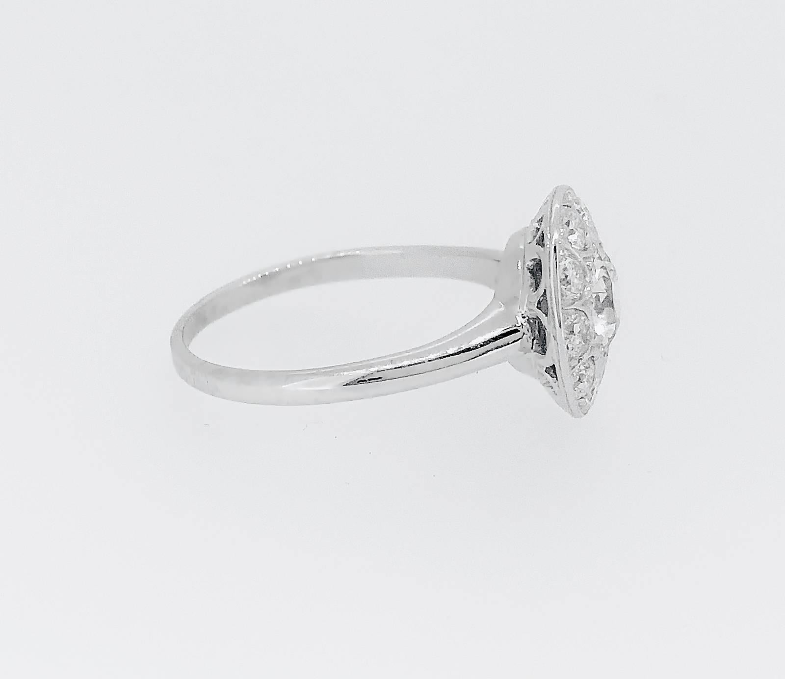 A hard to find Art Deco halo Antique engagement ring that features a .80ct. apx. Transitional cut diamond with VS1 clarity and J-K color. It is surrounded in a halo style by .50ct. apx. T.W. of transitional round diamonds with VS2-SI1 clarity and