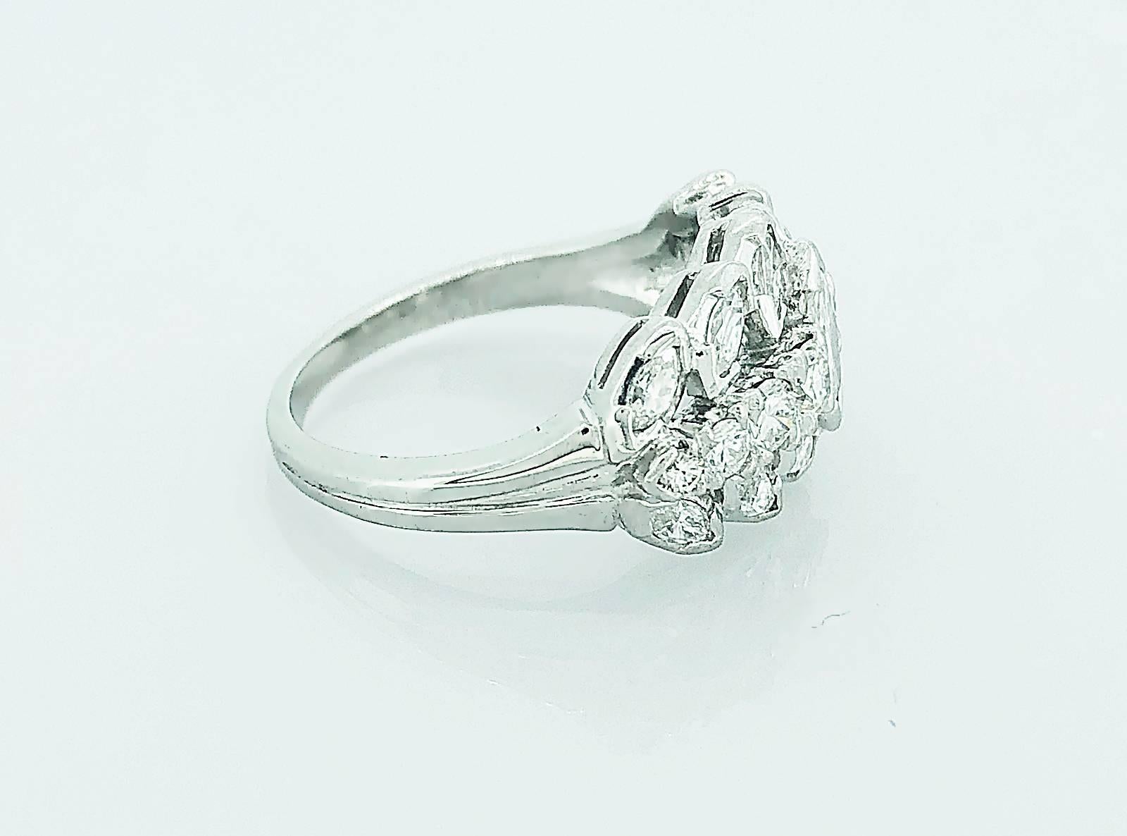 A dazzling Art Deco diamond engagement - wedding band that features a .45ct. marquise cut center diamond with VS1 clarity and G color. Accenting this fantastic marquise are 1.70ct. apx T.W. of marquise and round brilliant cut diamonds on the top and