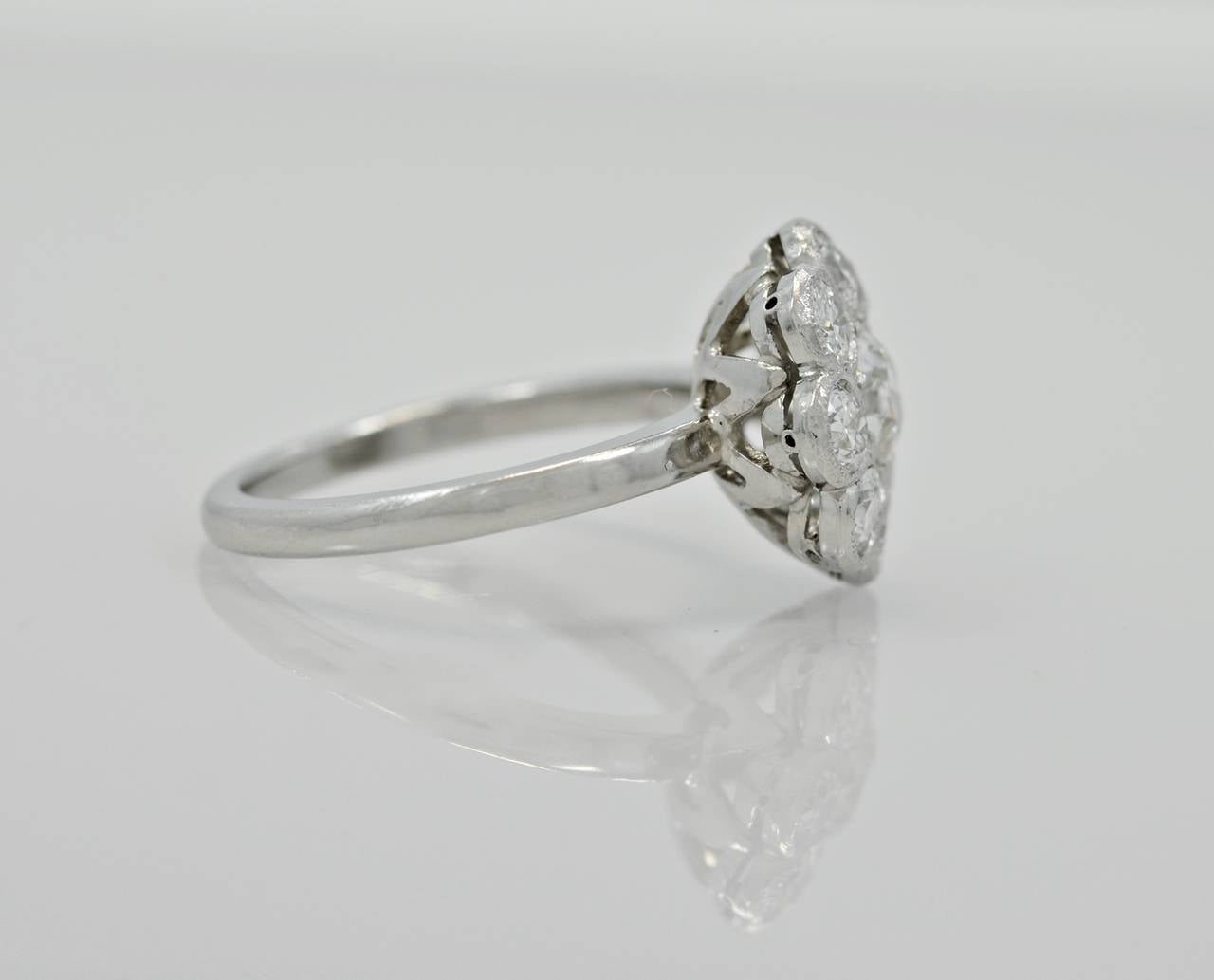 J35063 

Extravagant Edwardian platinum ring featuring a .60ct. apx. center diamond and 1.00ct. apx. T.W. diamond melee. The clarity is VS2 and H-I color. The flower design was popular in rings and brooches from the time period of c. 1910-1915.